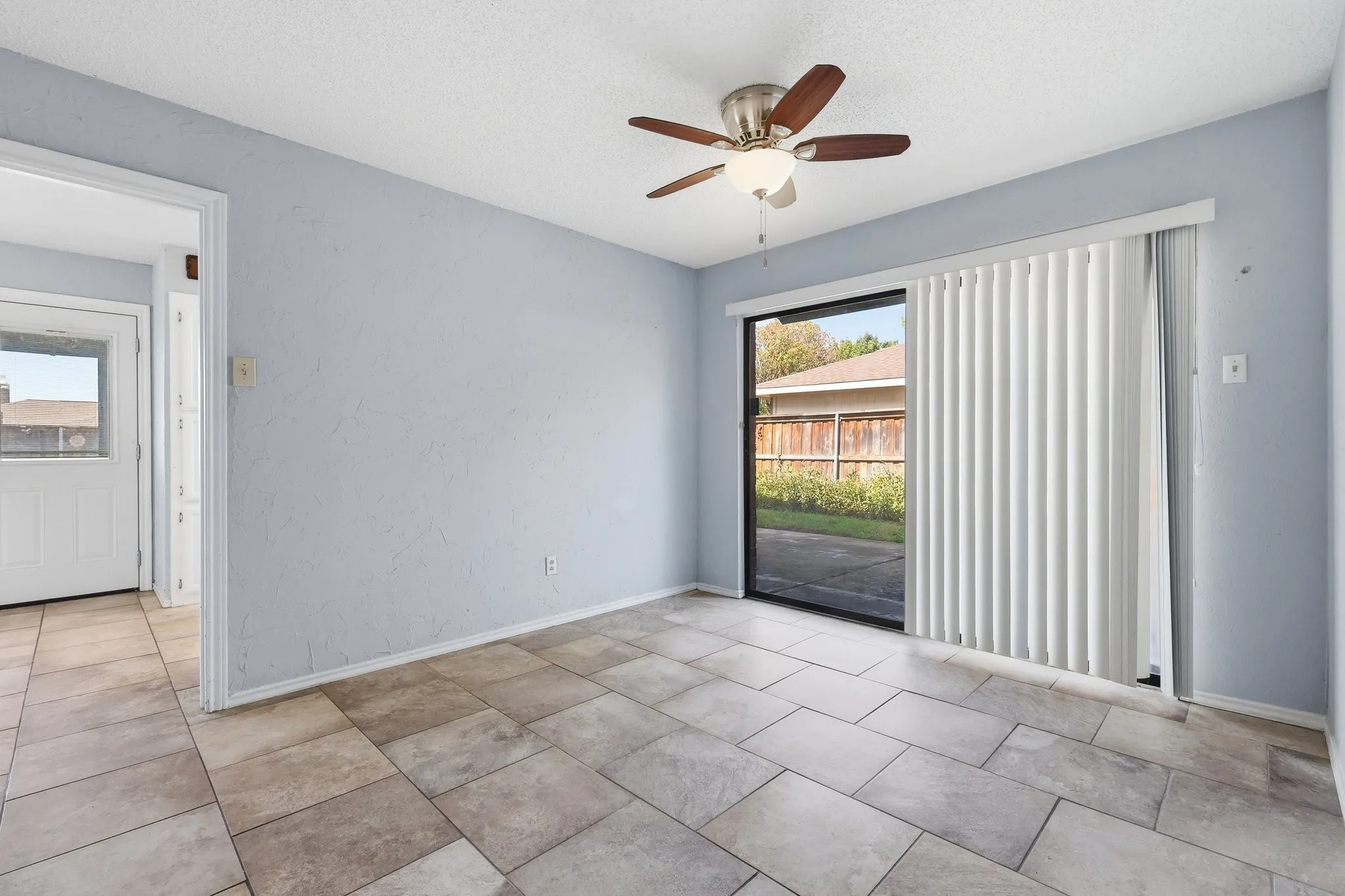 Dining Room with sliding glass door to one of the patio areas. There is also a wet bar area in this space.