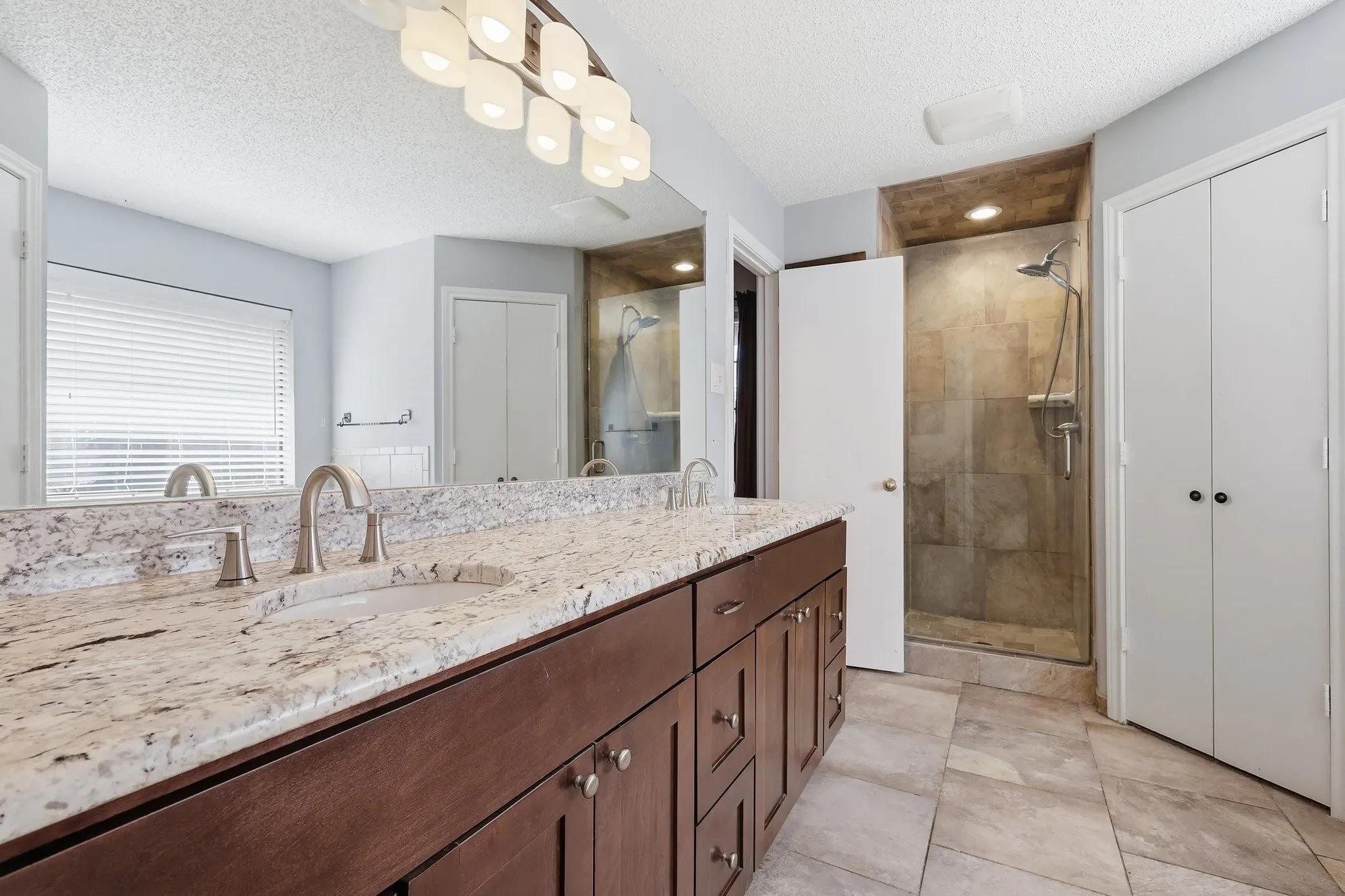 Granite countertop with dual sinks and a lot of storage!  Separate tiled shower and TWO walk in closets!!