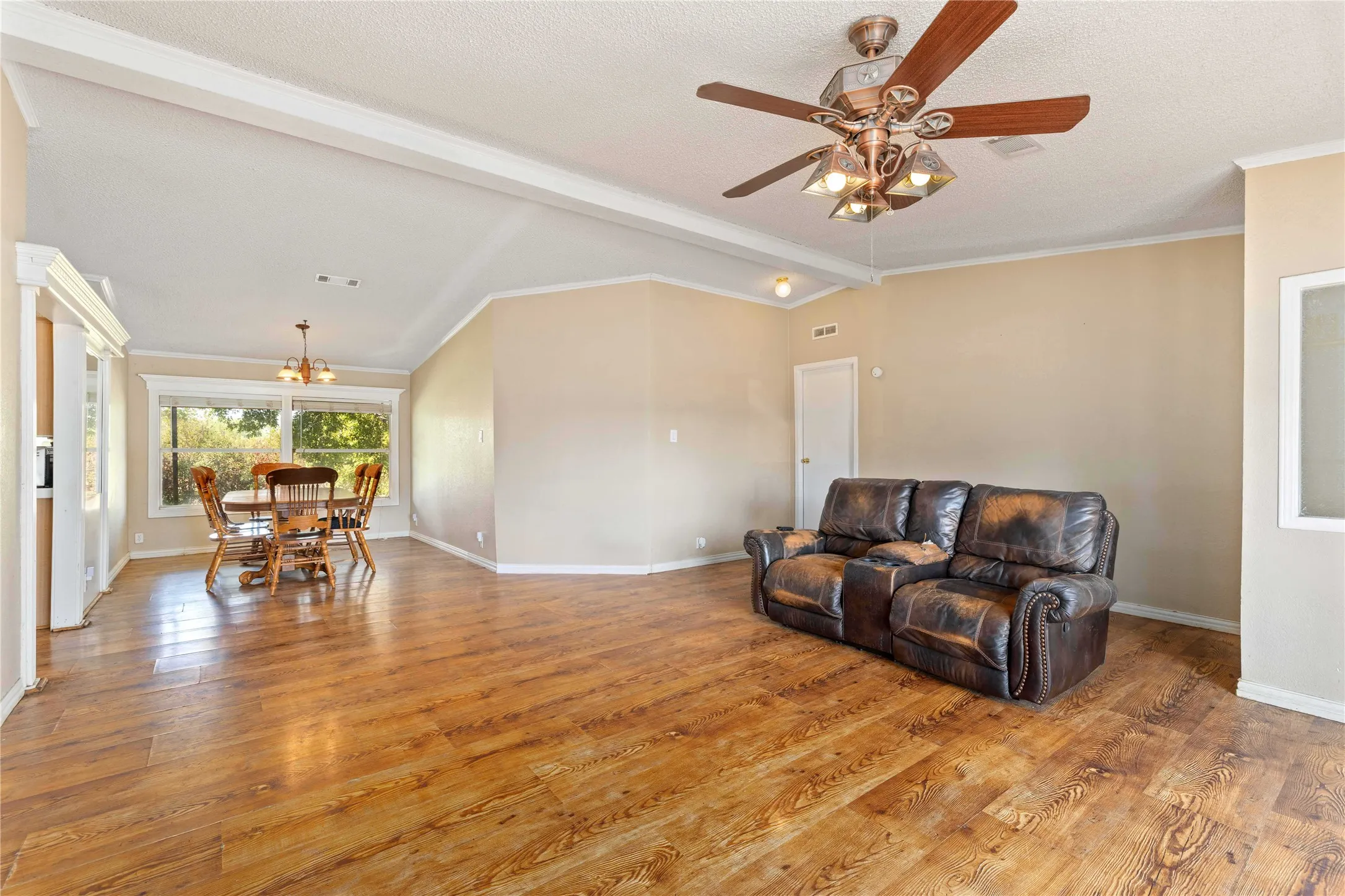 From the front door you will enter into the living room and dining room, the primary bedroom is through the white door on the right side of the living room