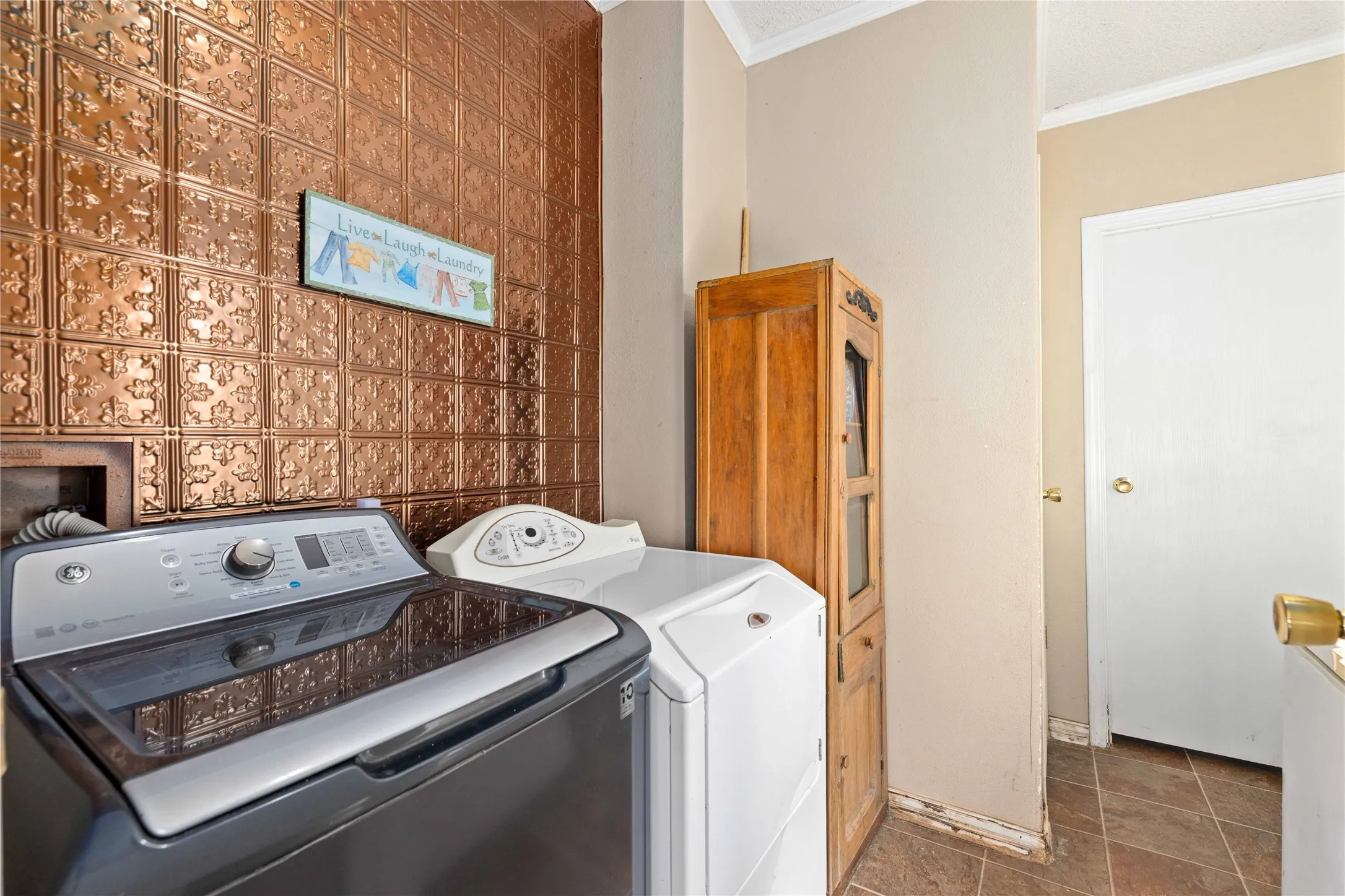 Laundry room has storage and an exterior door to the side deck. Great location to drop your boots after being in the field.