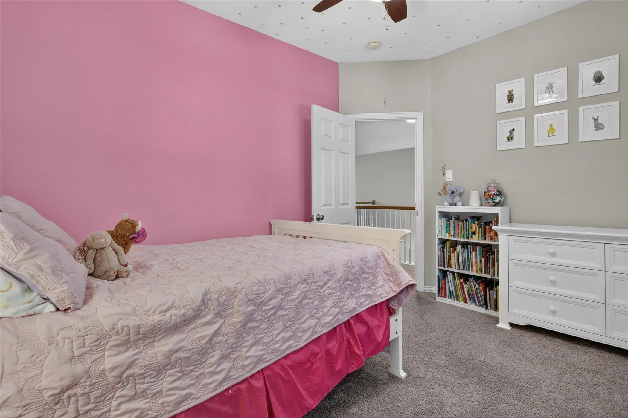 Bedroom featuring neutral wall-to-wall carpeting, a multi-paneled interior door, and a ceiling fan with integrated lighting