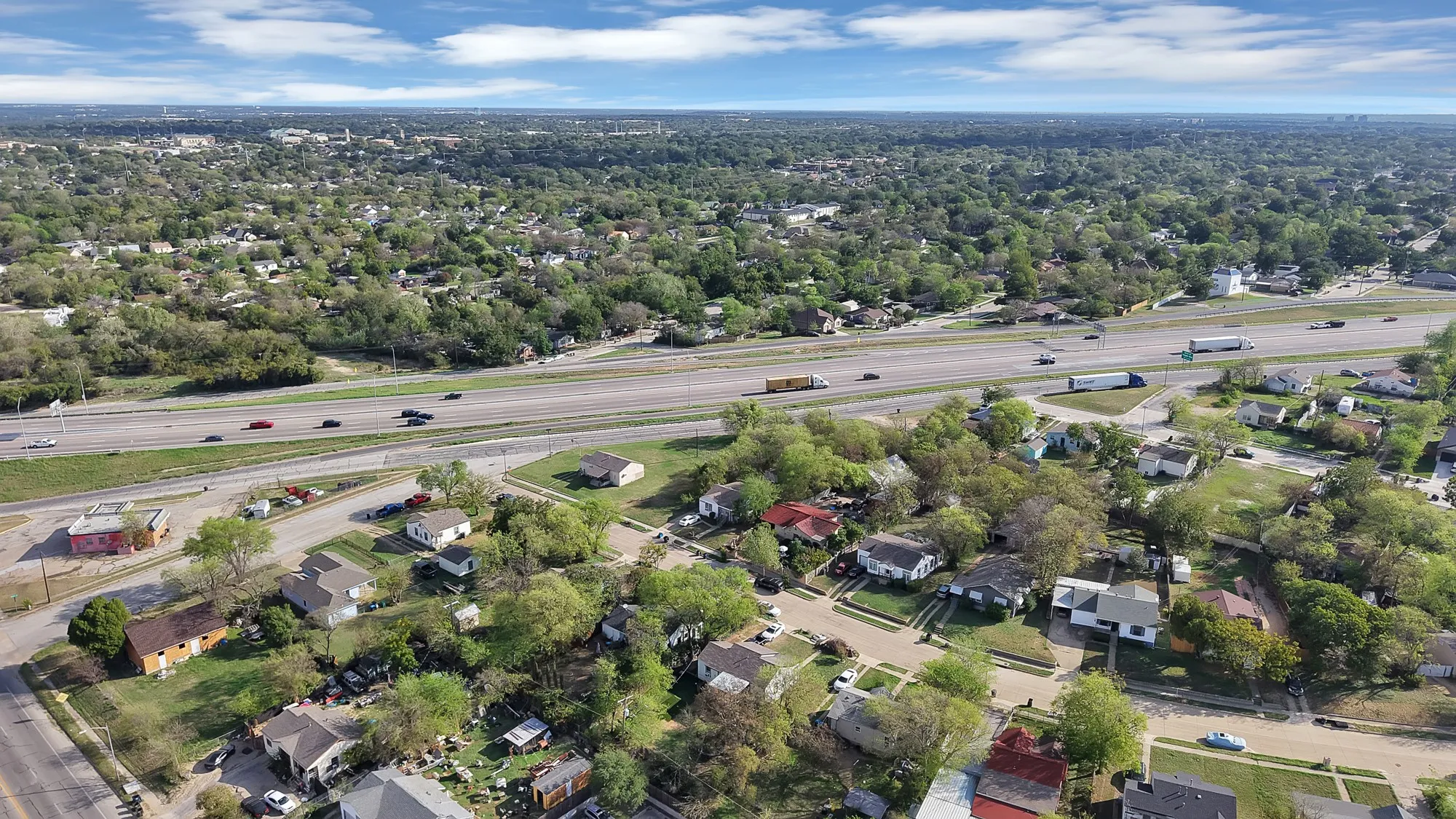 Aerial perspective of the residential area featuring mature trees, established landscaping, and grid-patterned streets
