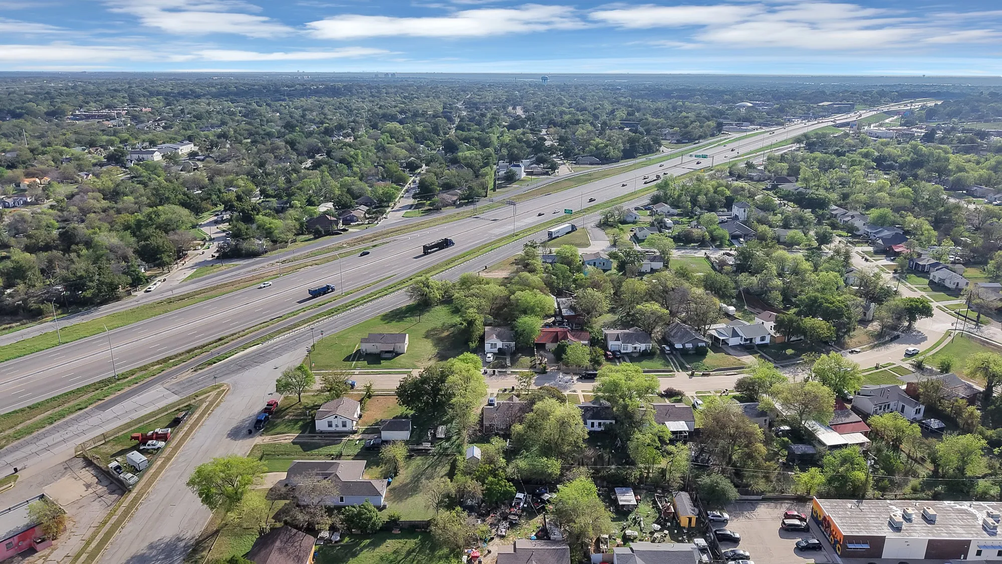 Aerial perspective showcasing the surrounding neighborhood and regional thoroughfare