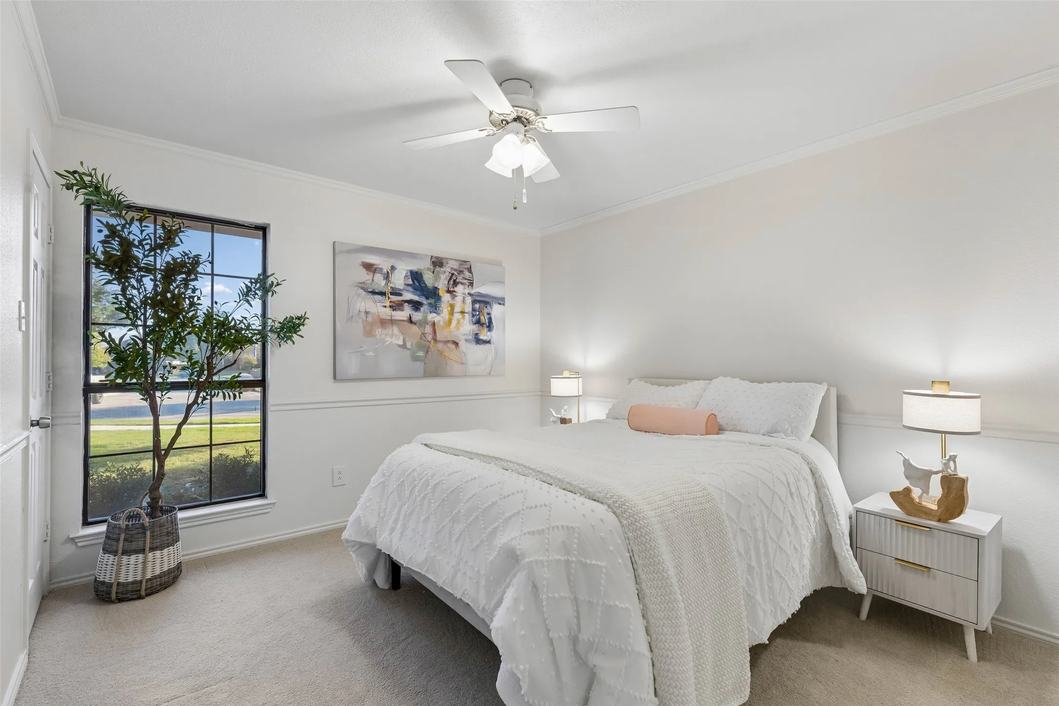 Neutral wall color, grid-patterned window, crown molding, chair rail, and white ceiling fan with integrated light fixture