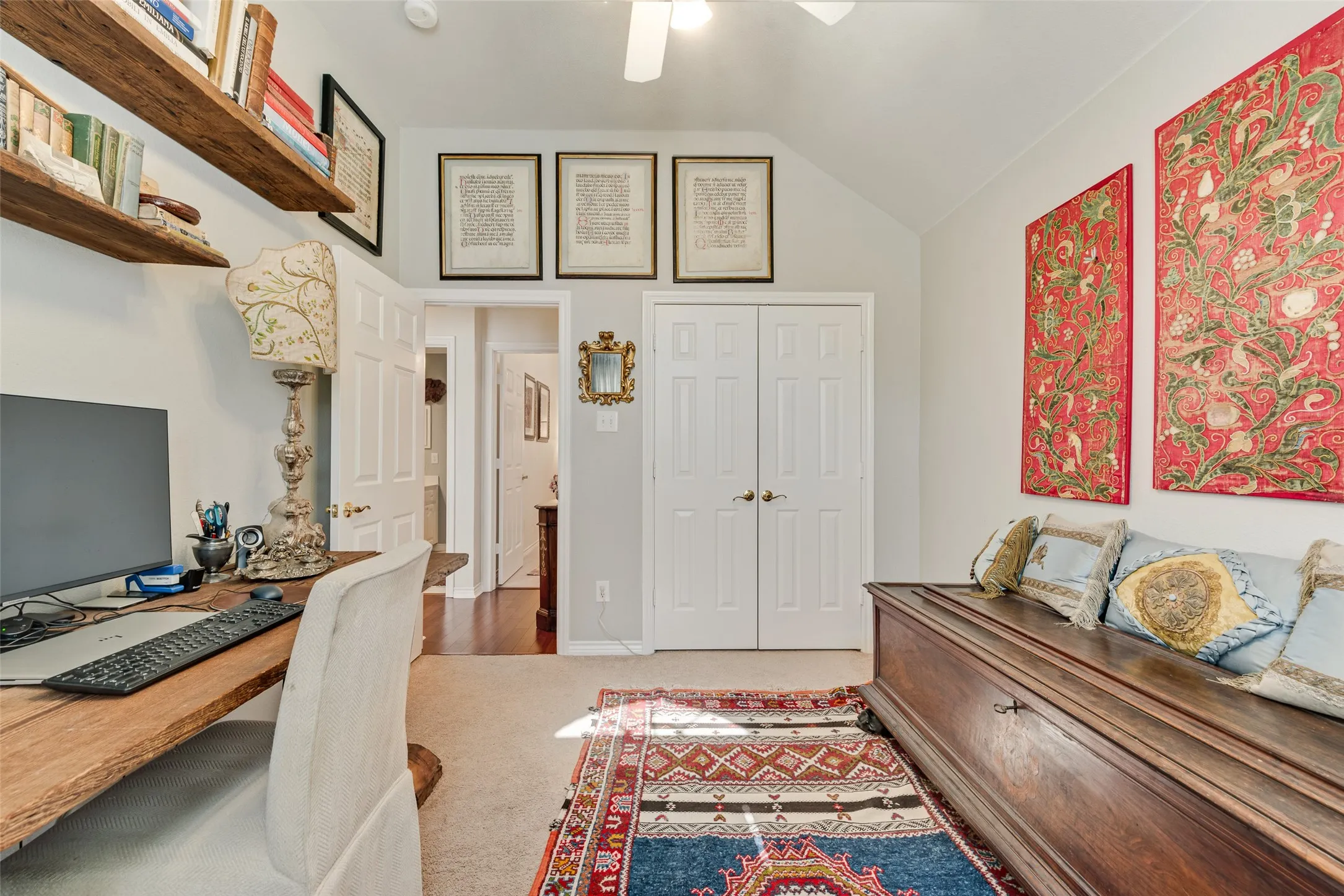 Vaulted ceiling featuring a central light fixture and built-in wooden shelving
