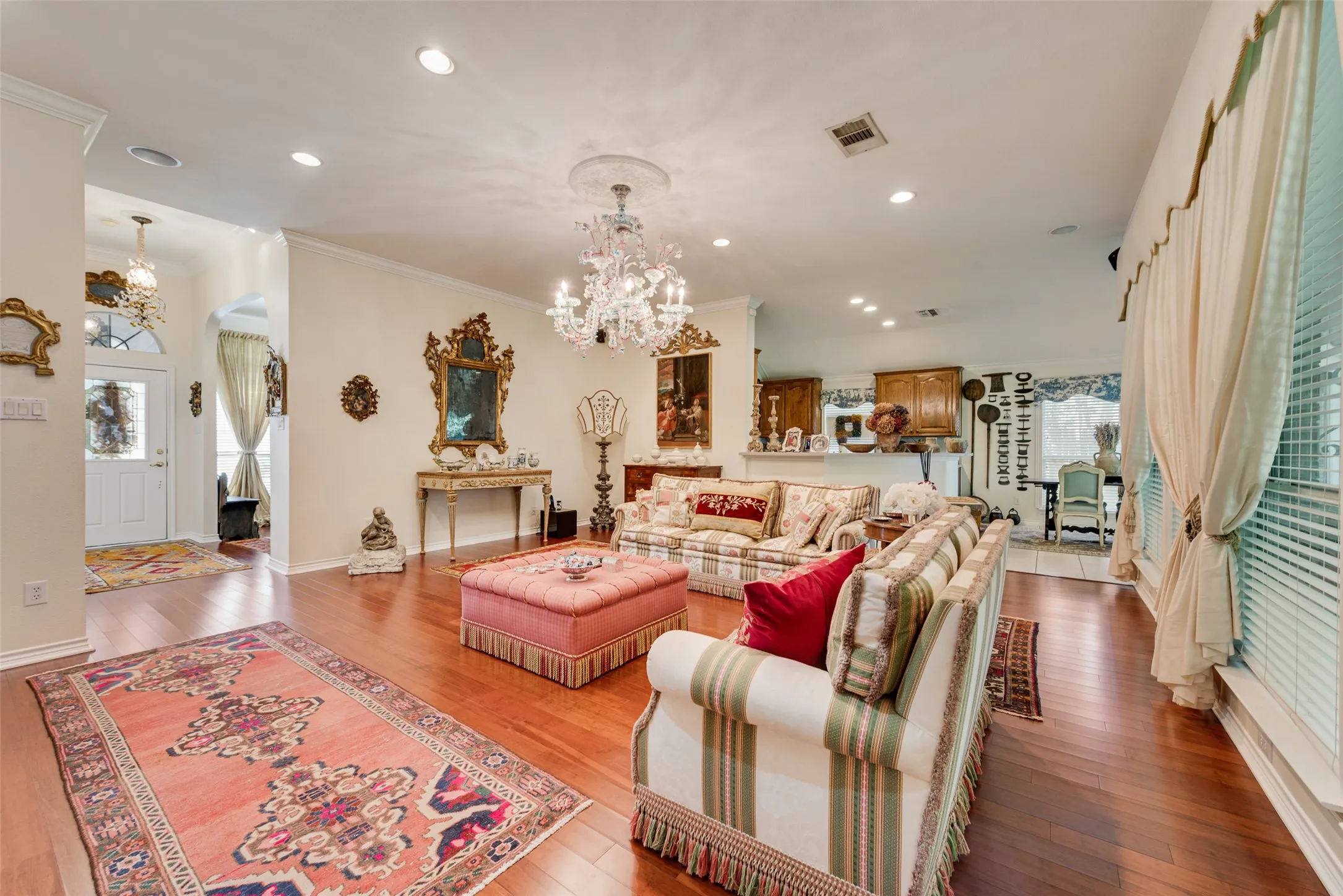 Open-concept interior featuring wood-finish flooring, recessed lighting, crown molding.