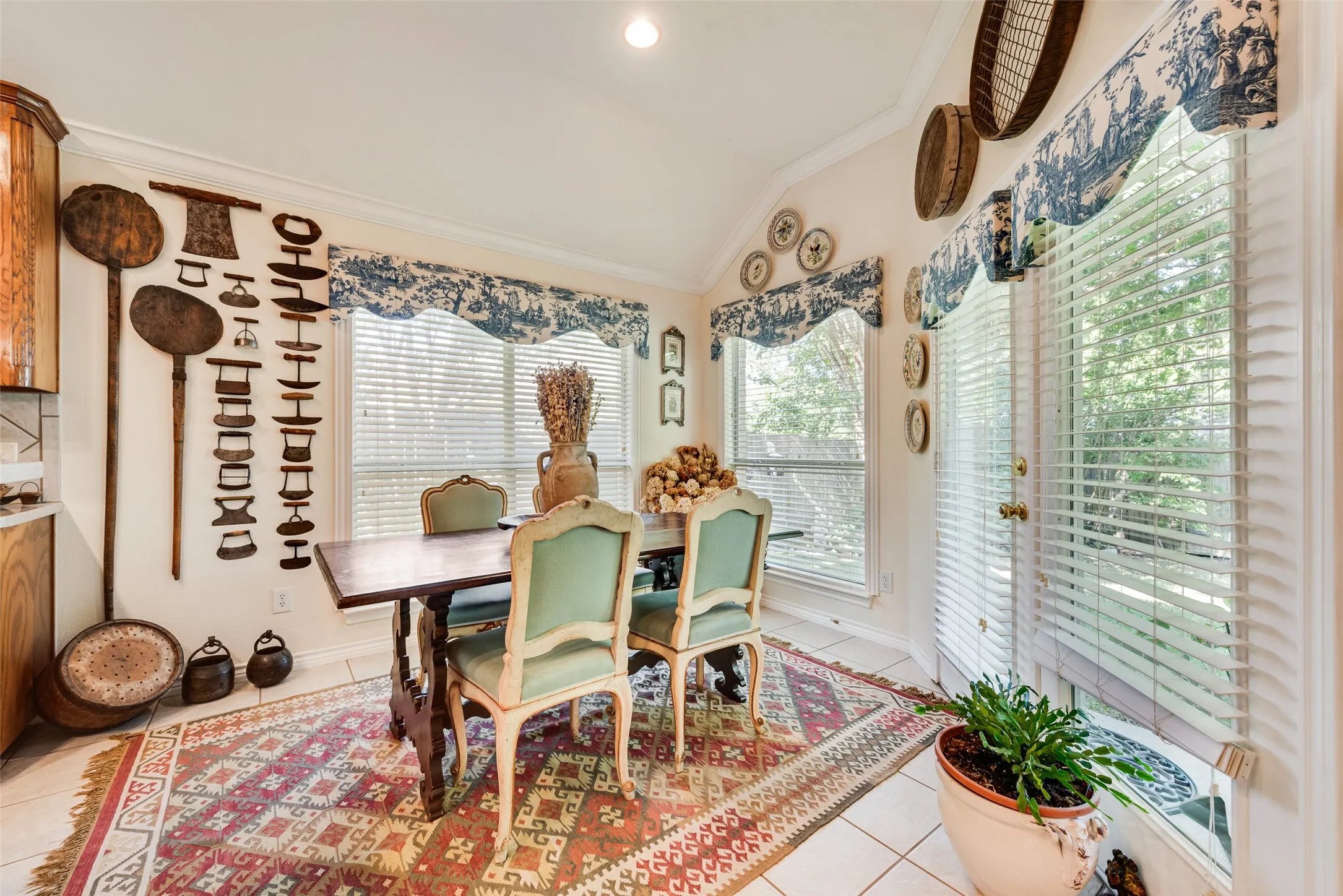 Vaulted ceiling, ceramic tile flooring, and multiple large windows providing abundant natural light