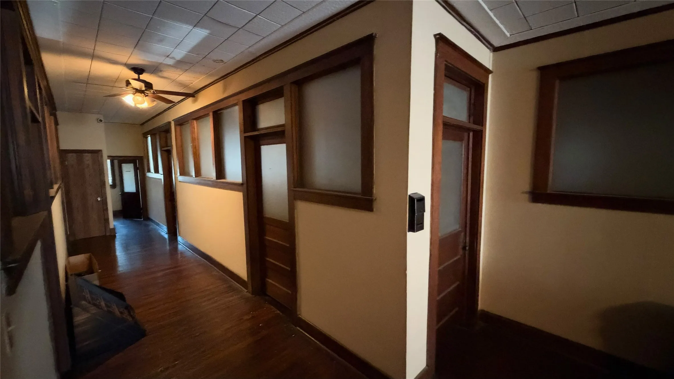 Hallway with original frosted-glass office doors and transoms