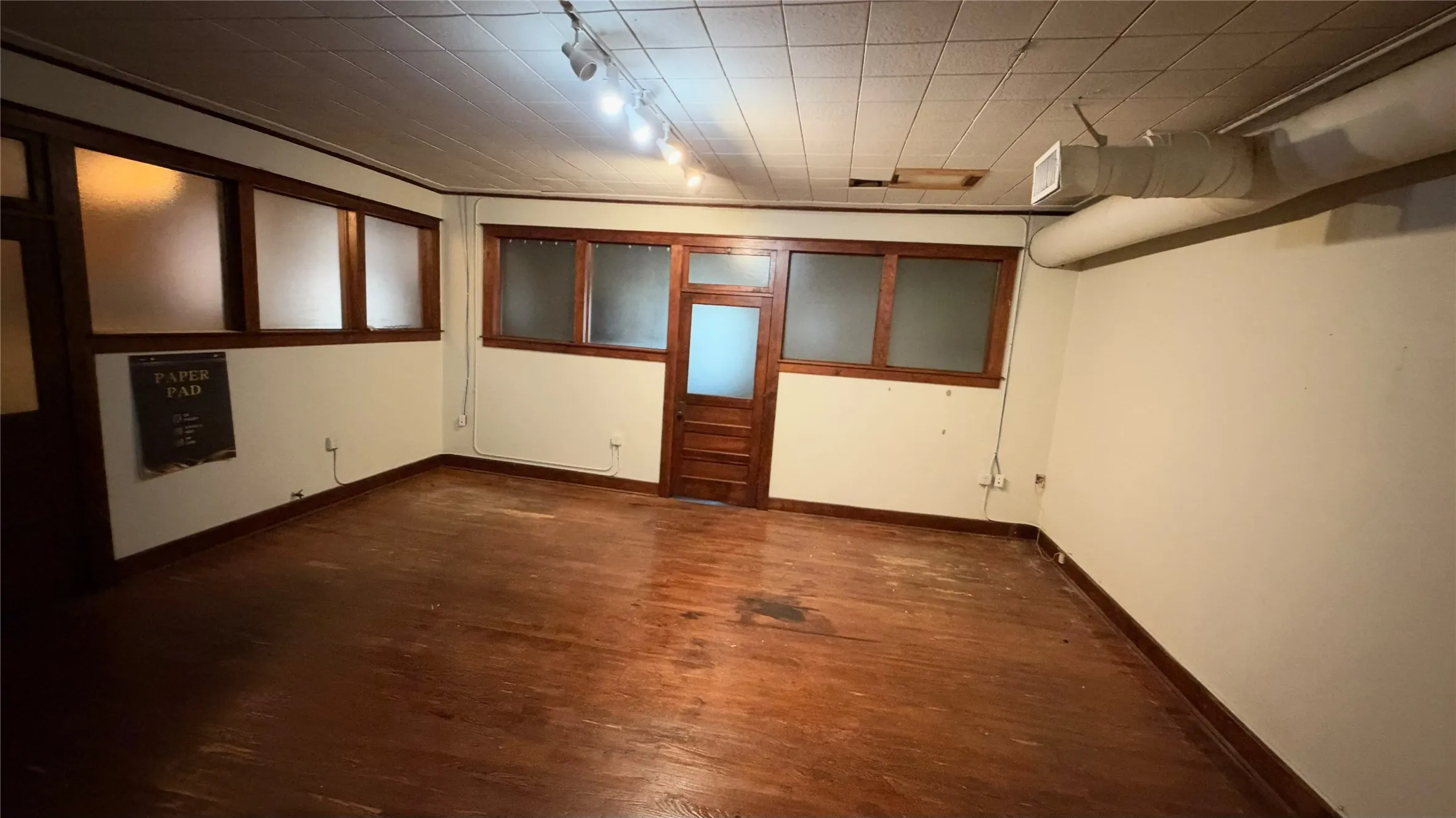 Private office with original hardwood floors and transom door