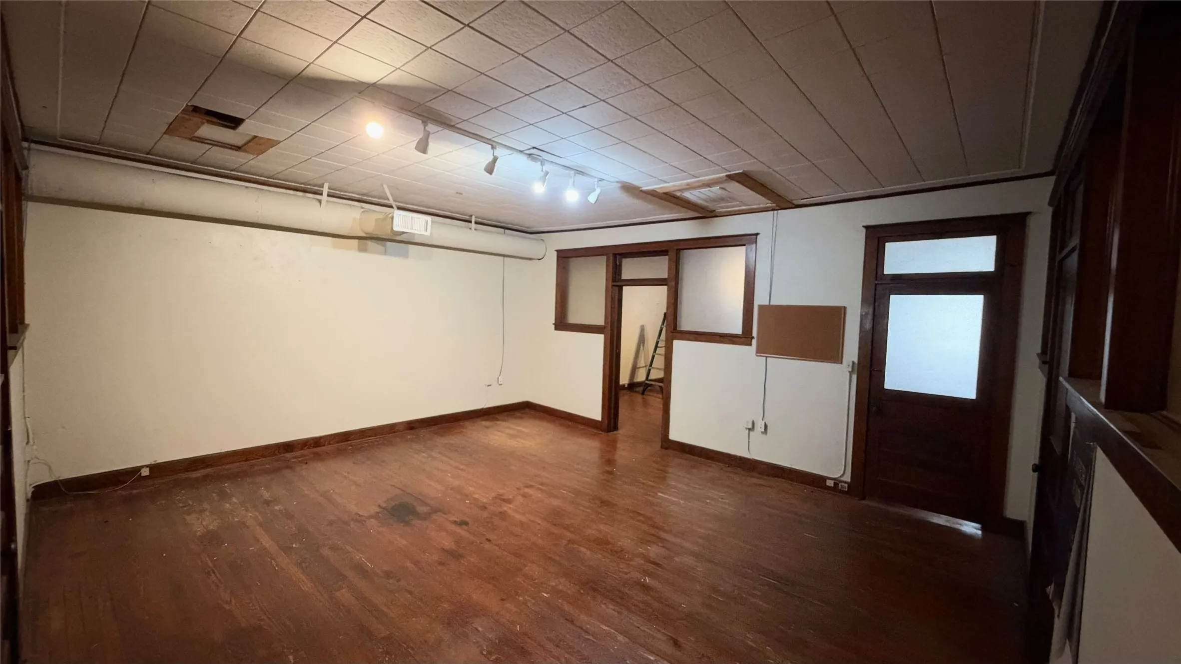 ~358 SF office or conference room with original hardwood floors and wood trim