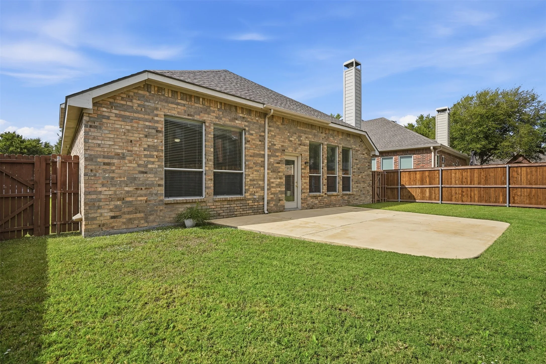 Low maintenance backyard with extended patio.