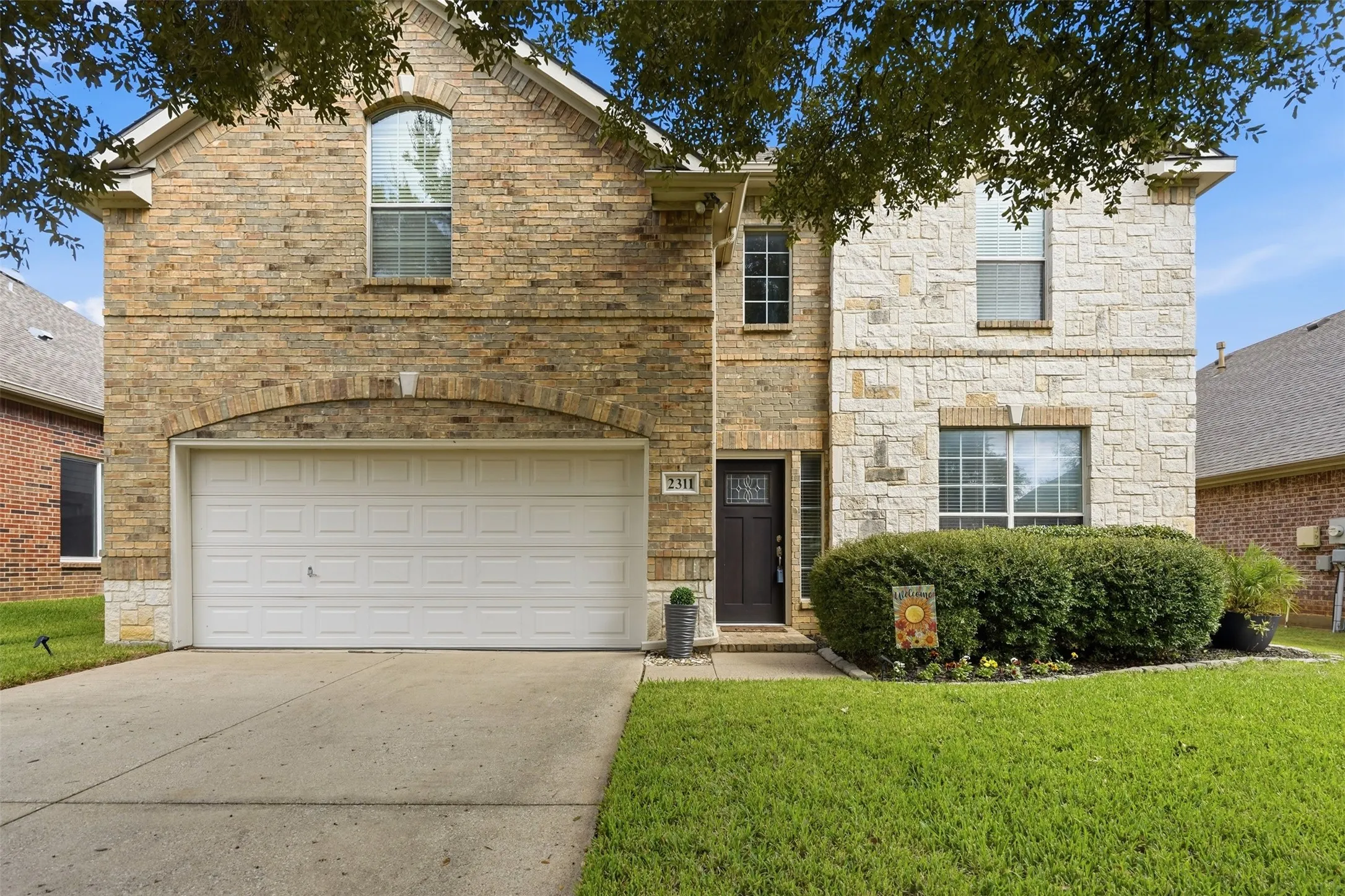 Beautiful blend of brick and stone exterior.