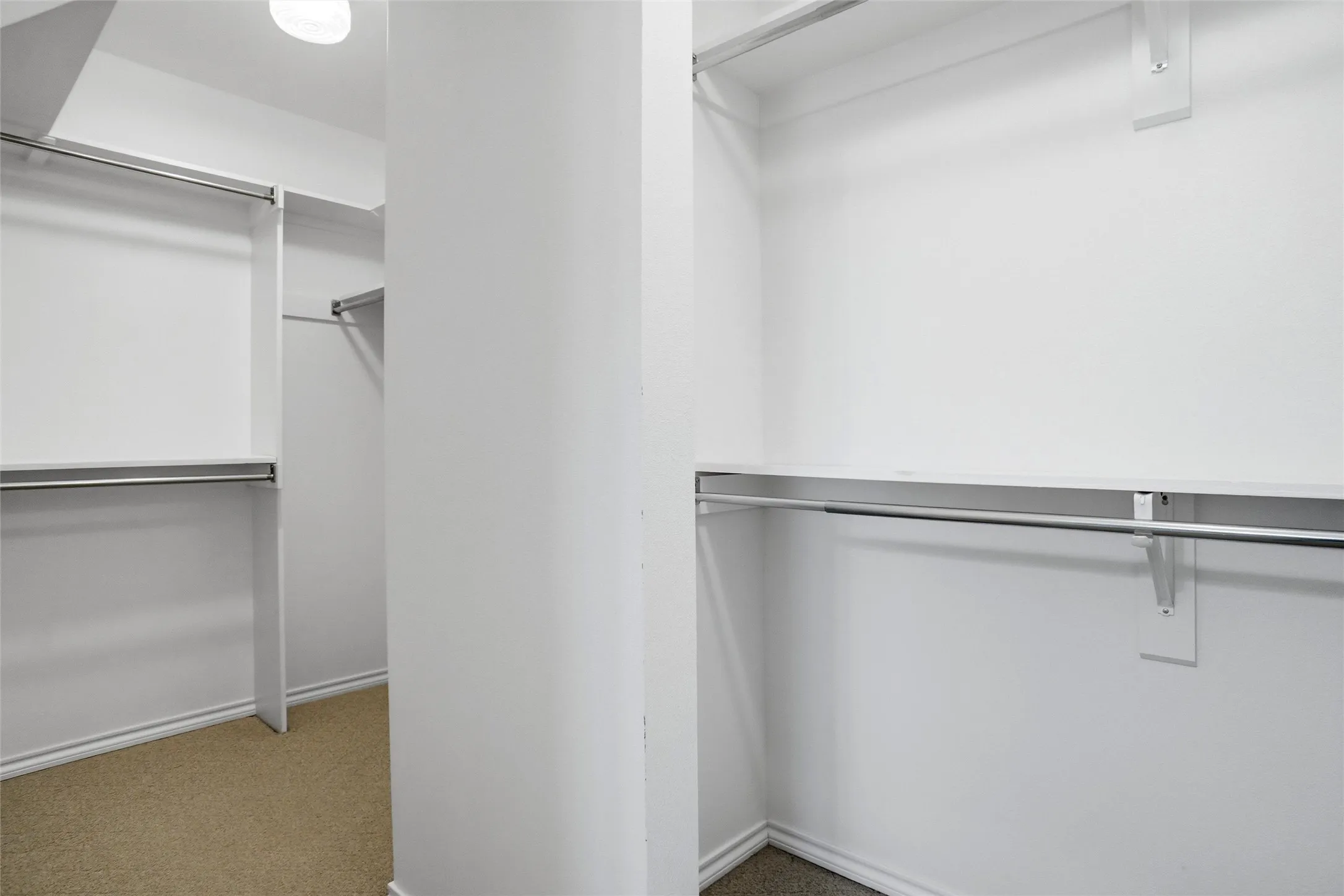 Lots of room in this large closet complete with built-in shelving and hanging rods