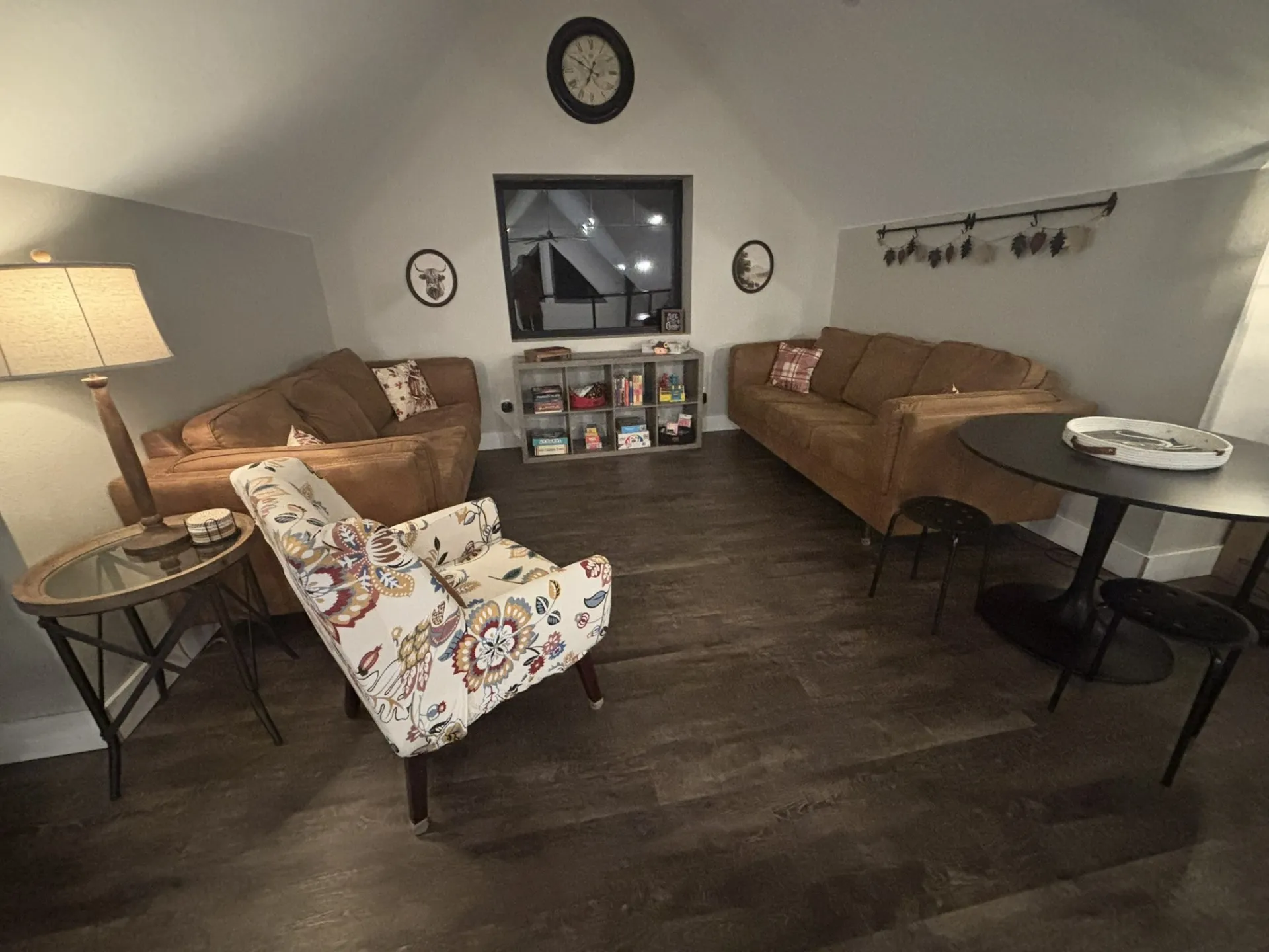Vaulted ceilings, wood-finish flooring, and a rectangular window
