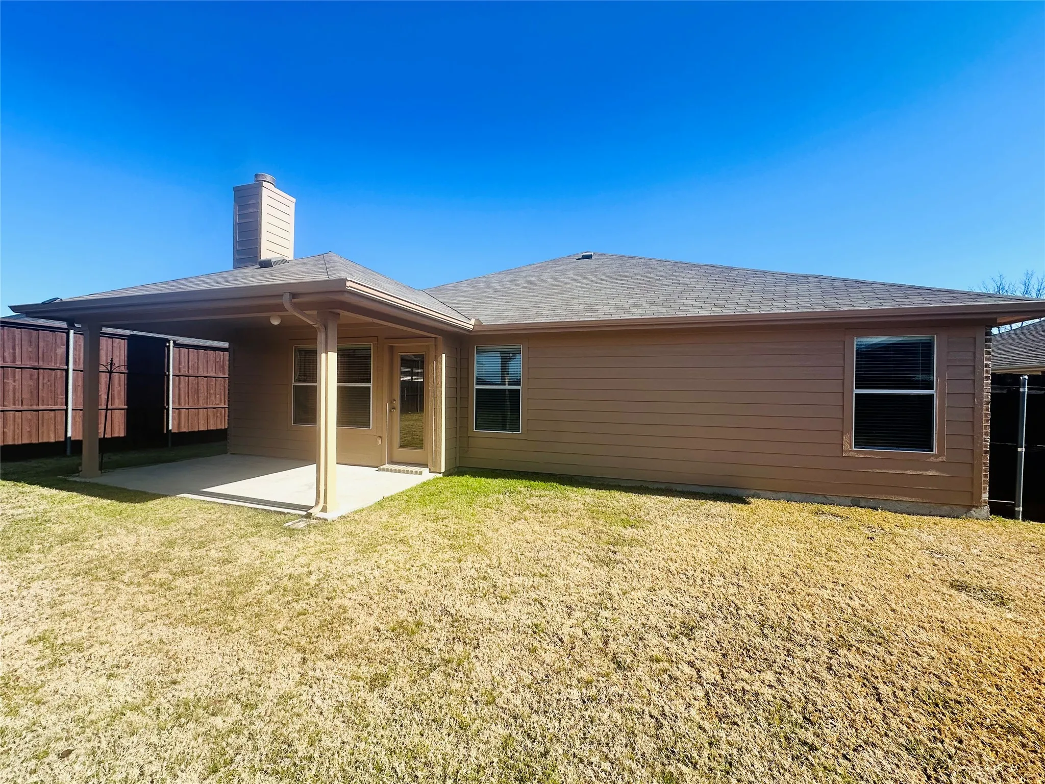 Rear view of house featuring a yard and a patio
