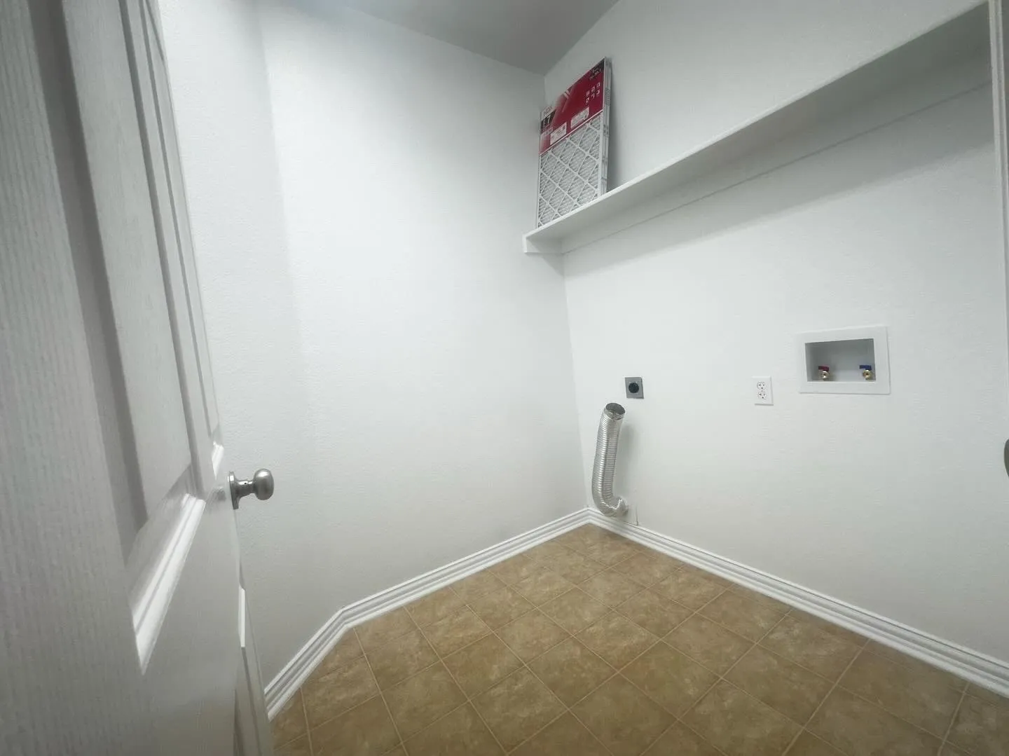 Clothes washing area featuring hookup for a washing machine, tile patterned flooring, and hookup for an electric dryer