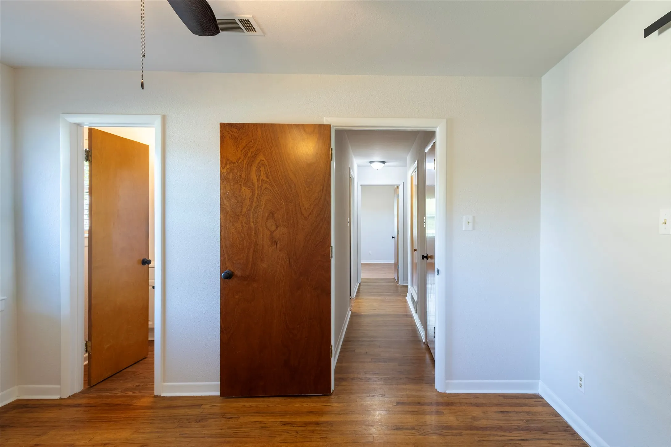 Wood-finish flooring, solid wood-finish interior doors, and ceiling-mounted lighting fixtures