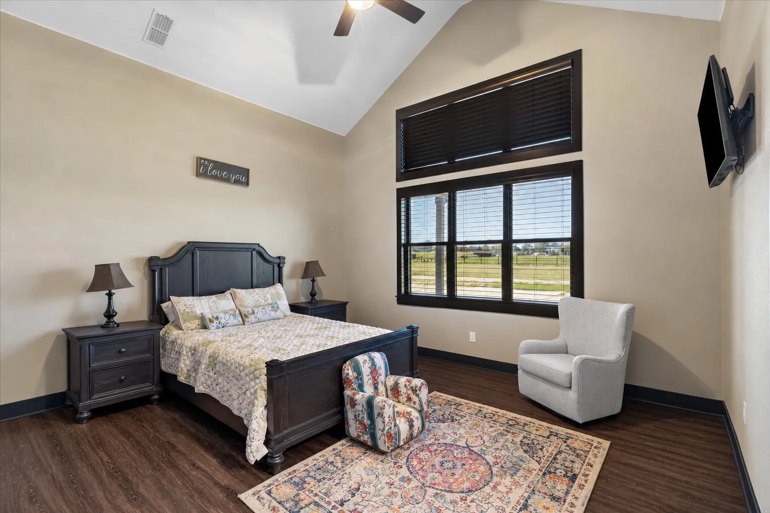 Vaulted ceilings, wood-finish flooring, and expansive windows featuring transom detailing