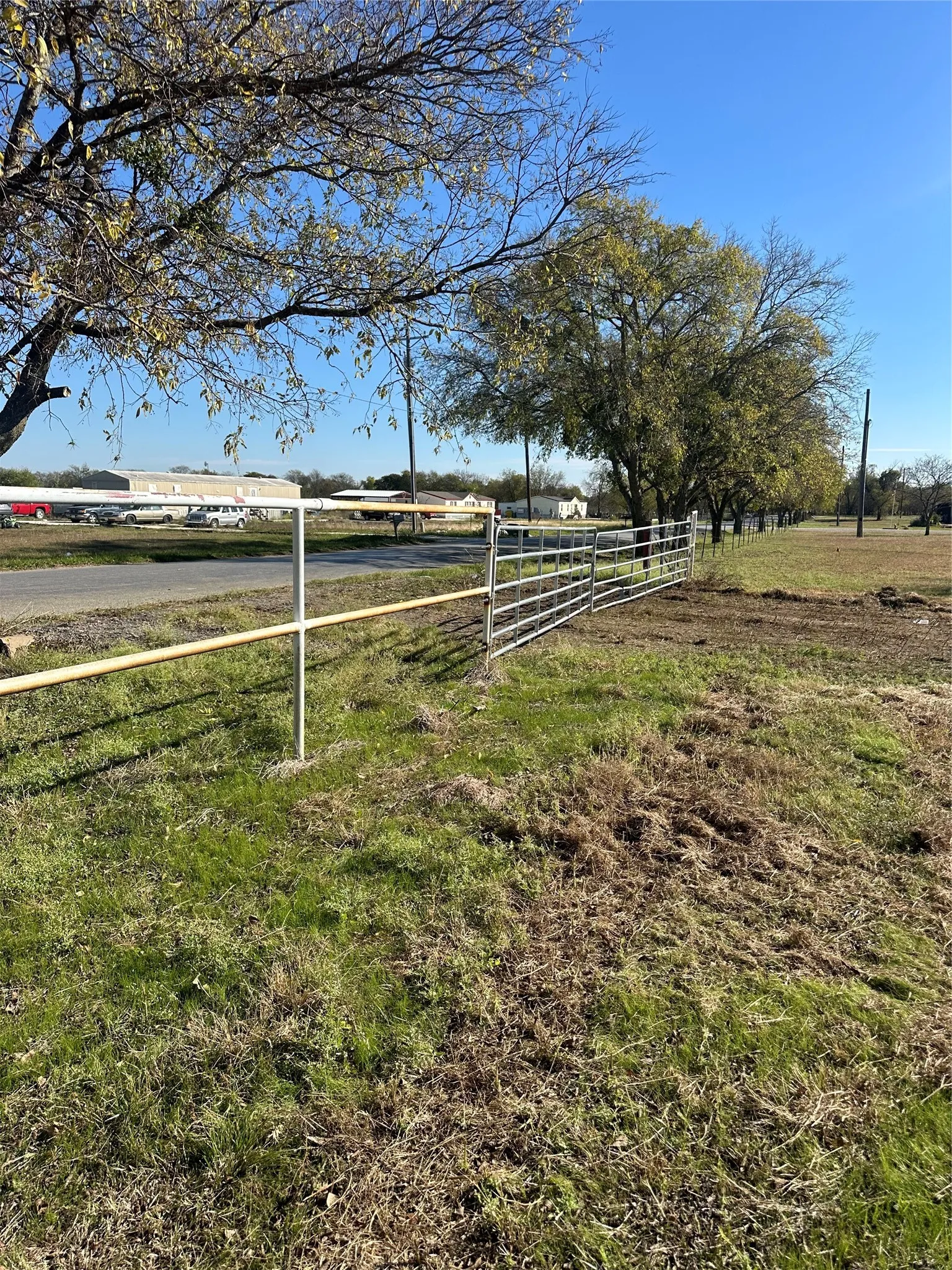 Property perimeter featuring a metal rail fence