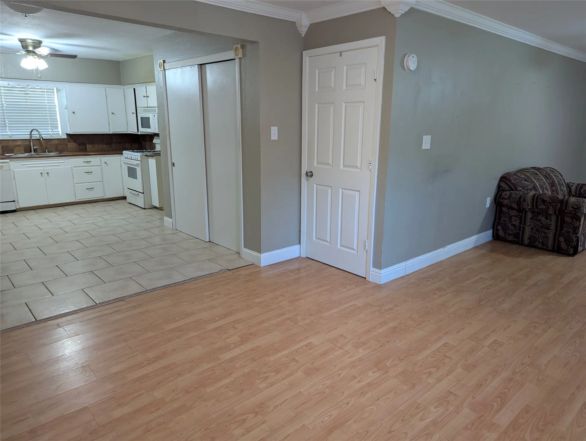 Open transition from the living area into the dining and into the kitchen.