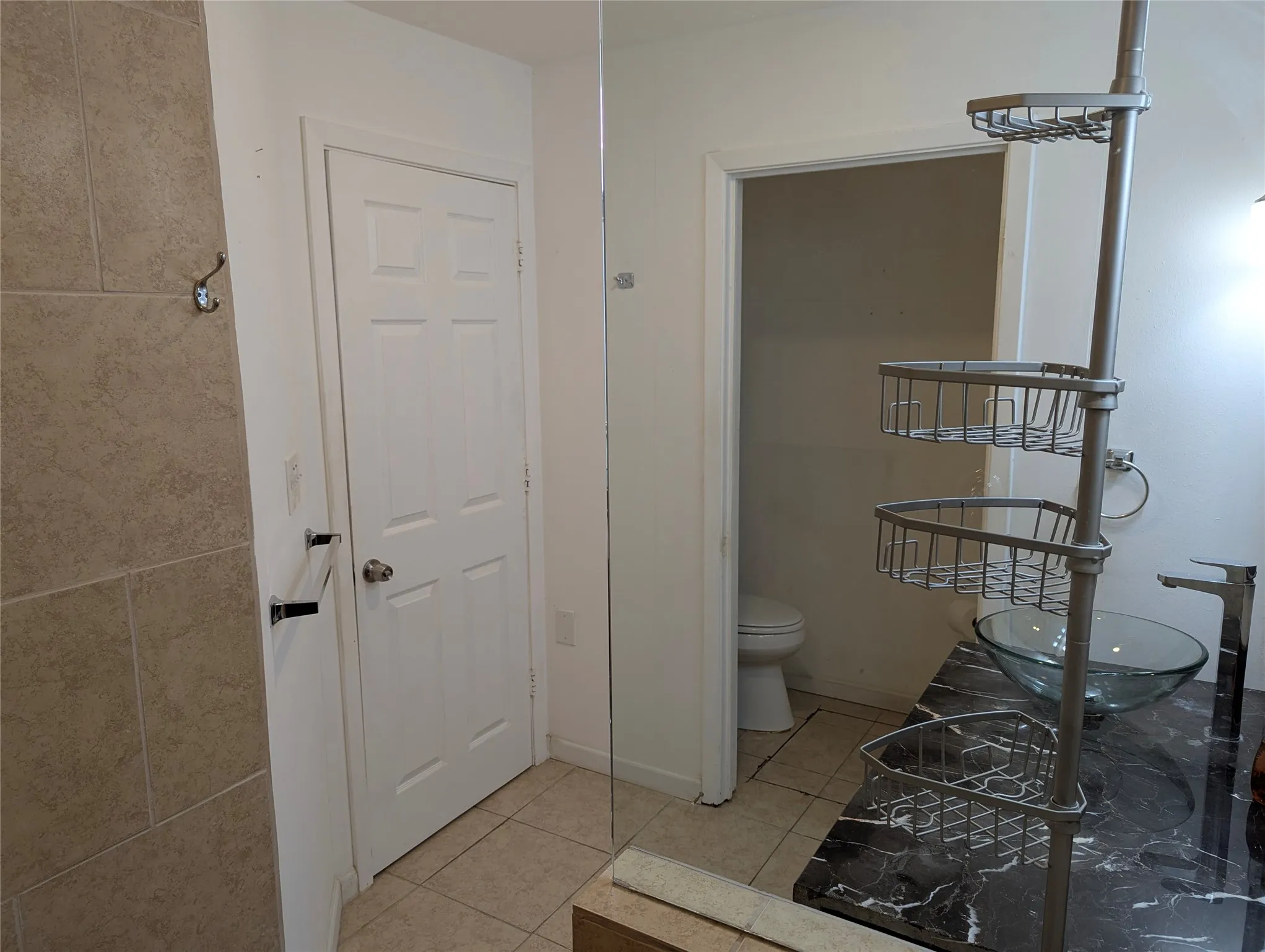 View 3: Additional view of the primary ensuite featuring built-in shelving for towels, toiletries, and extra storage.
