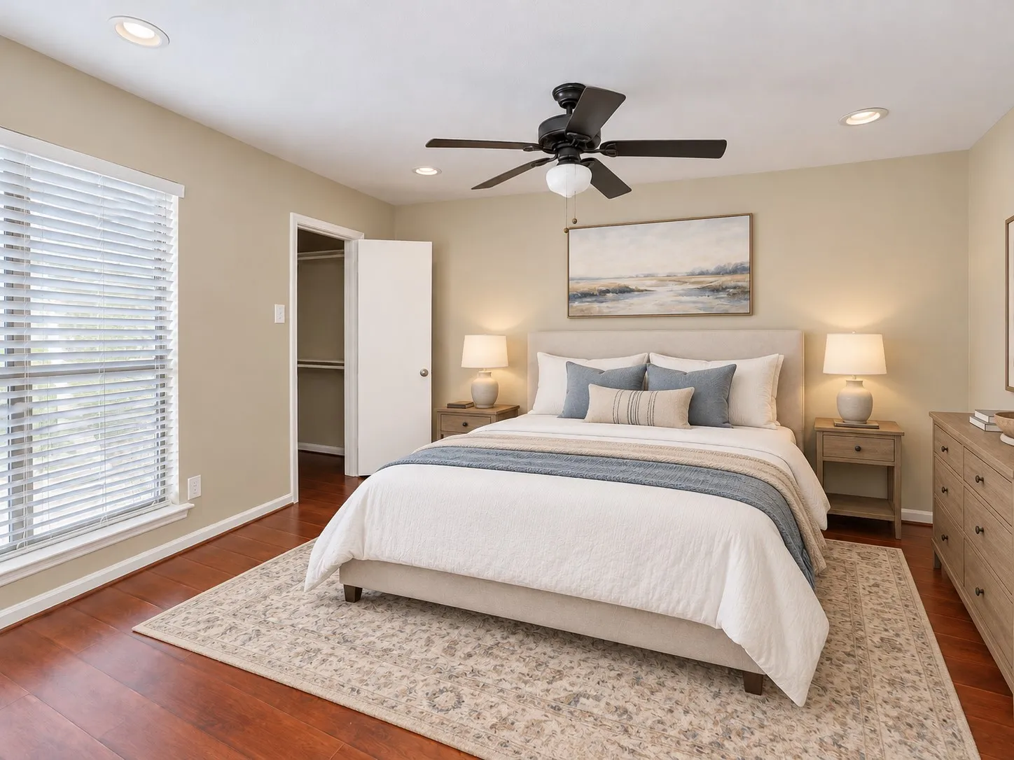 Room featuring wood-finish flooring, recessed lighting, and a multi-blade ceiling fan with integrated lighting