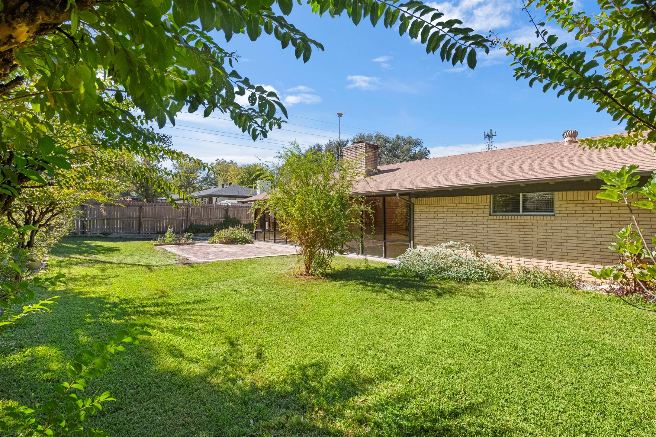 Mature trees and green space give the backyard room for play, gardening, or relaxing outdoors.