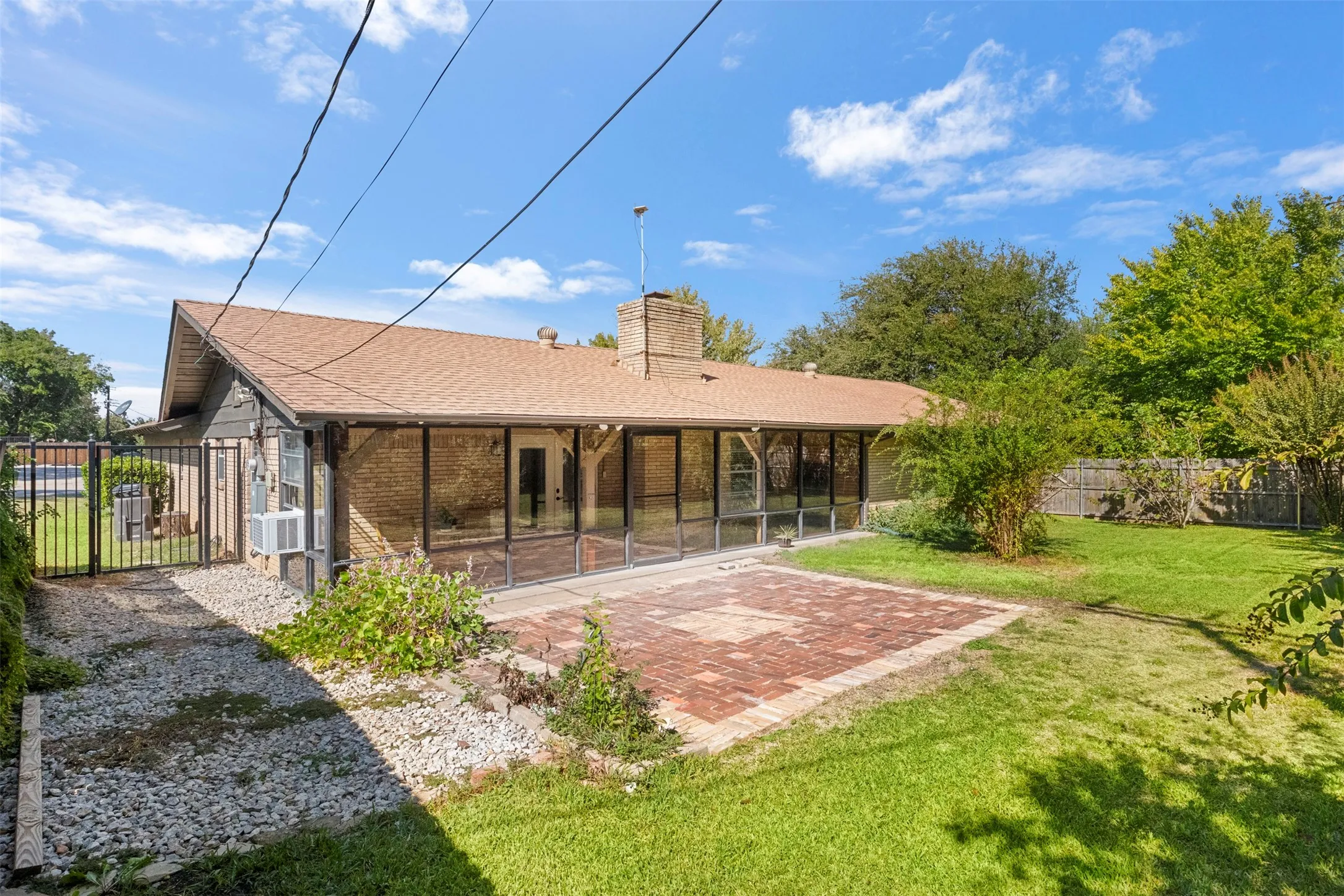 The screened porch stretches across the back of the home, connecting indoor and outdoor living.