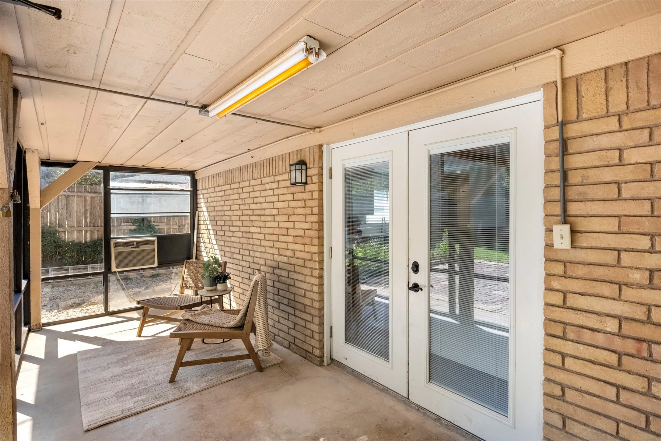 The screened-in porch includes a window A/C unit and heater for added comfort throughout the seasons.