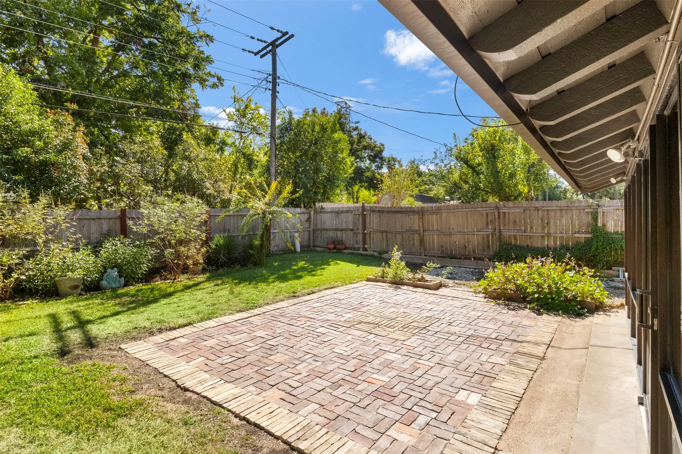 A large brick-paver patio extends the outdoor entertaining space beyond the screened​​‌​​​​‌​​‌‌​‌‌​​​‌‌​‌​‌​‌​​​‌​​ porch.