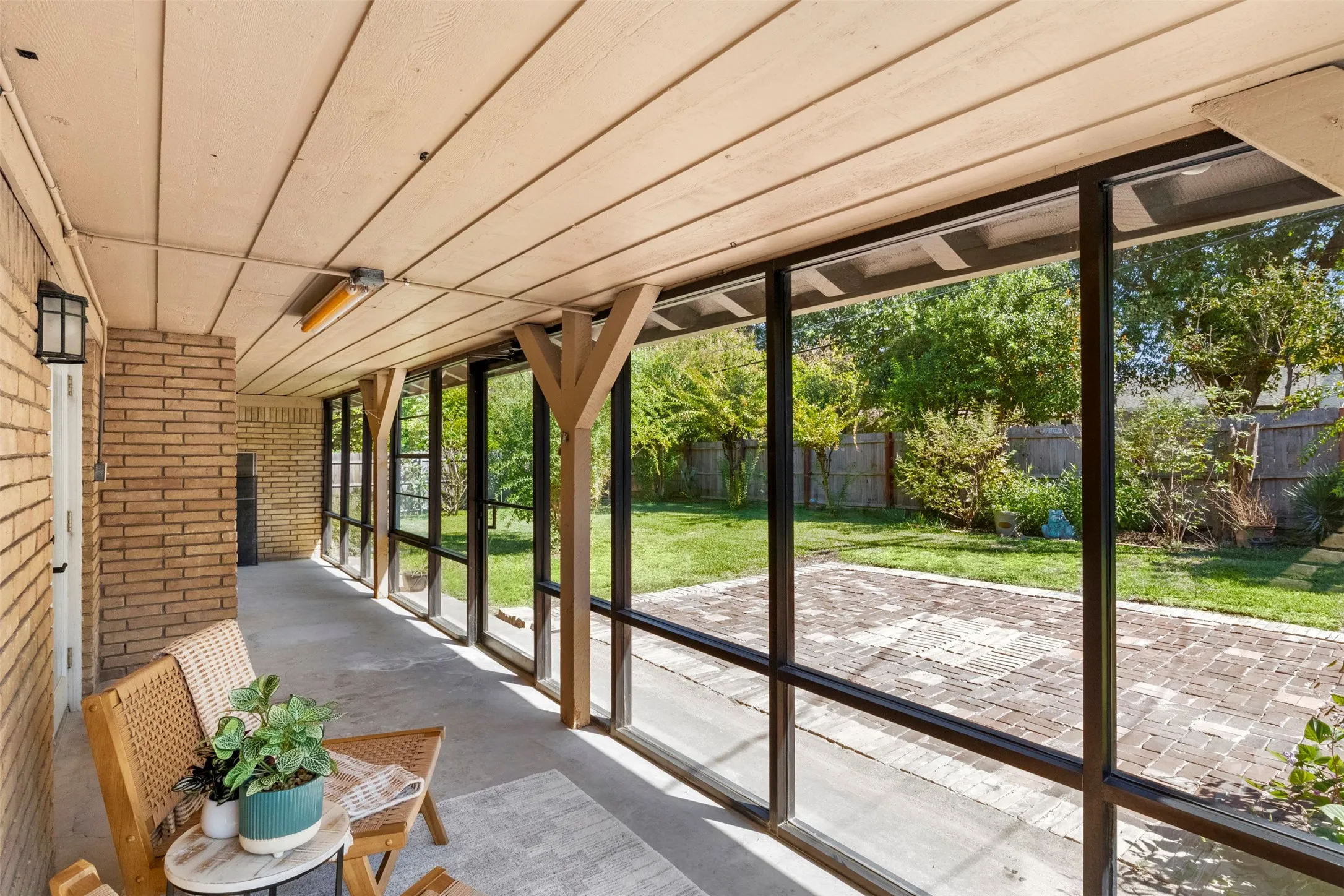 The screened enclosure lets you enjoy views of the backyard while staying sheltered from insects.
