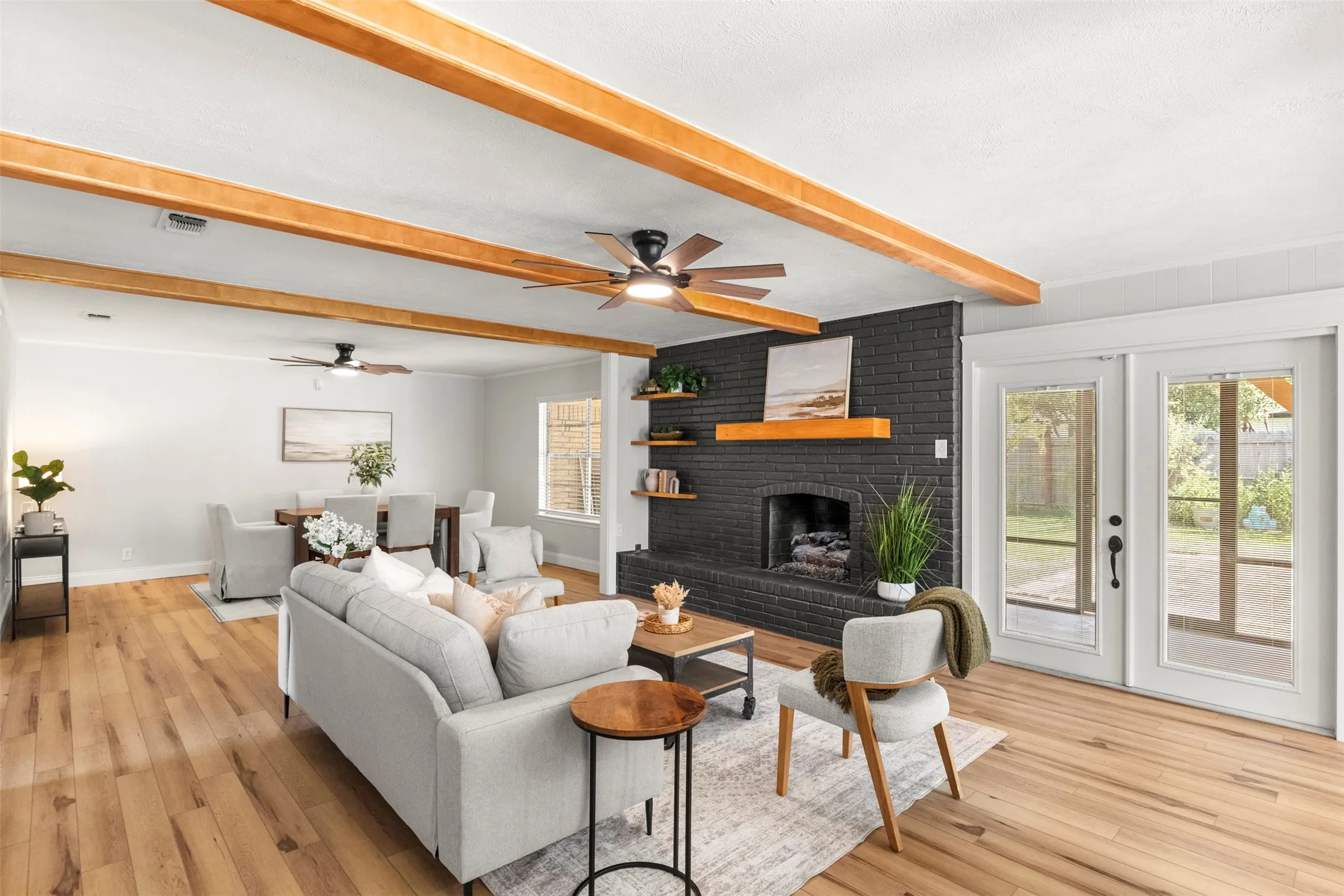 Updated flooring, modern finishes, and a statement fireplace bring the main living area together.