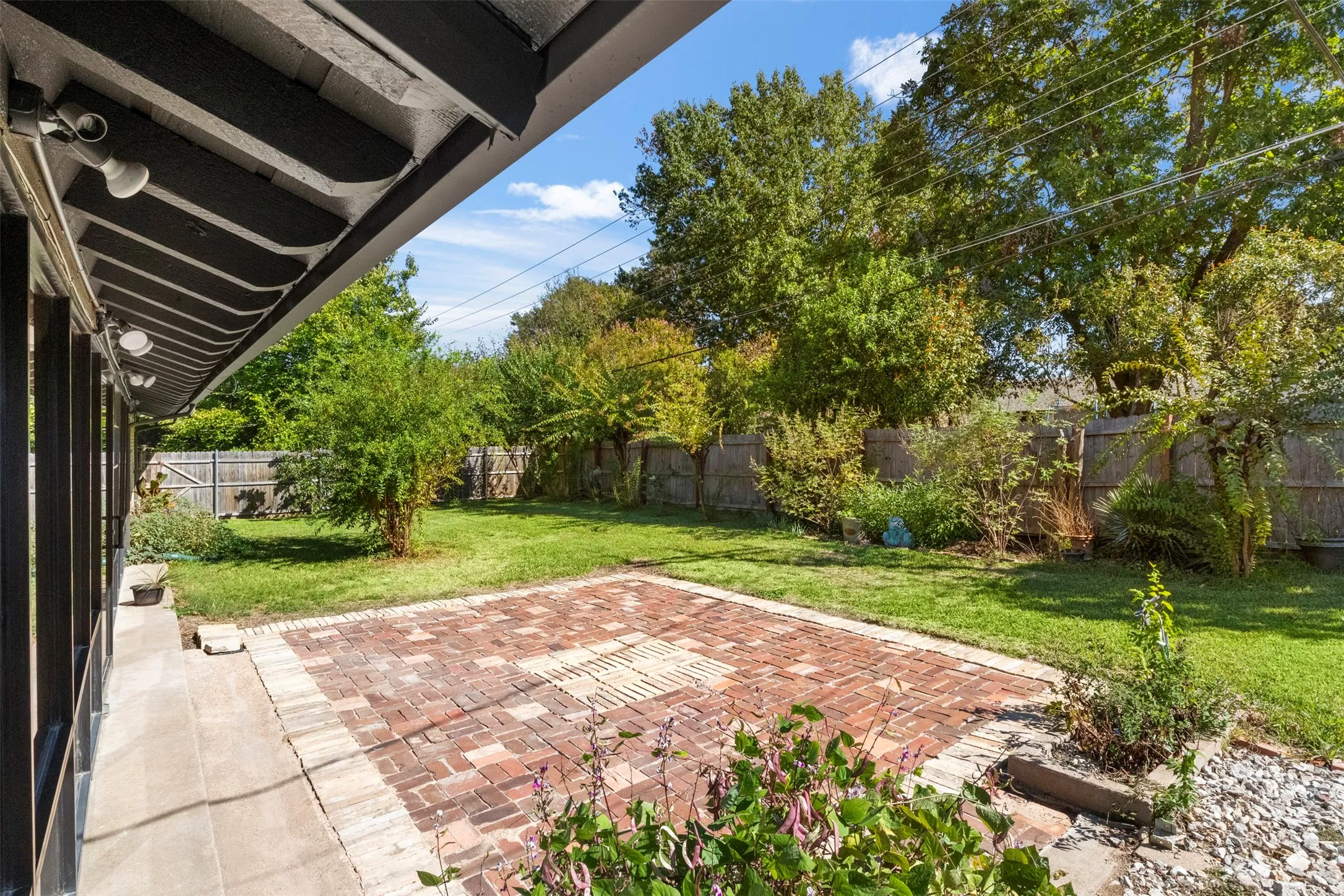 The backyard offers room for outdoor dining, seating, and gatherings around the paver patio.