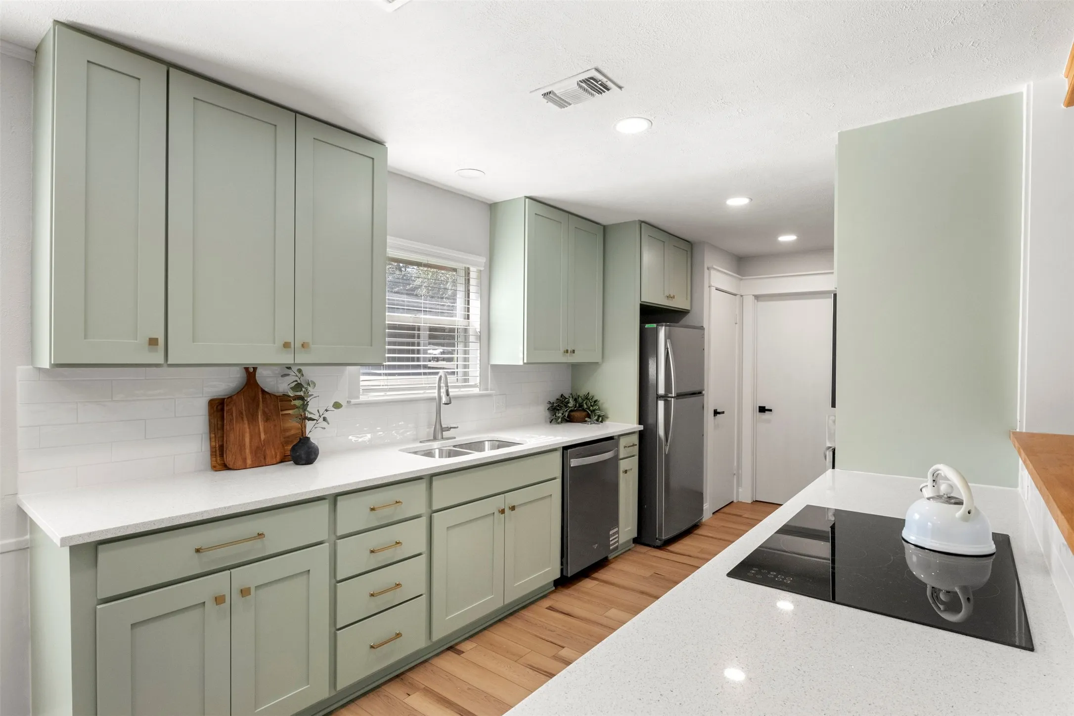 Quartz countertops, updated cabinetry, and soft-close drawers combine style with everyday function.
