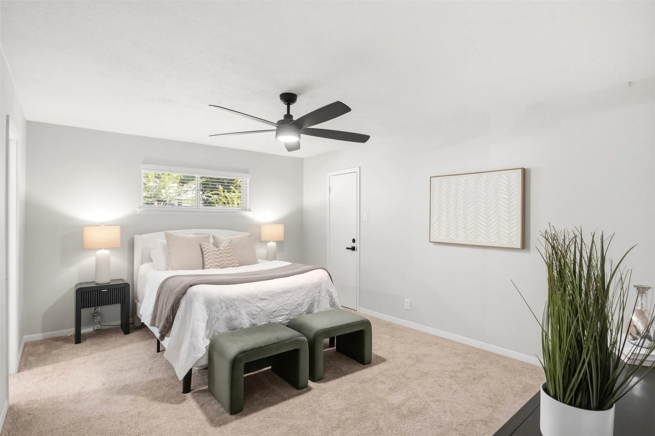 The spacious primary bedroom offers a comfortable retreat with room for a full bedroom setup.
