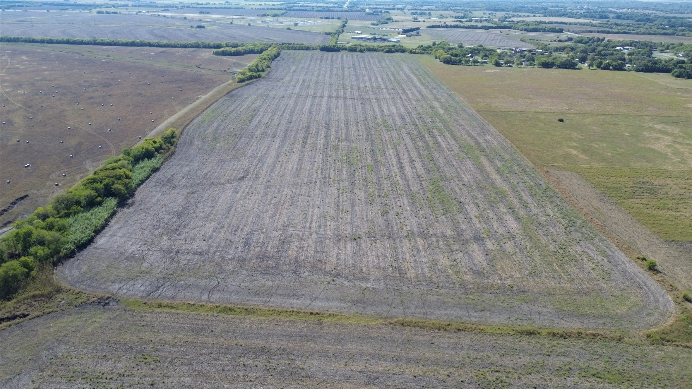 Expansive acreage featuring level topography, cleared open terrain, and mature perimeter tree​​‌​​​​‌​​‌‌​‌‌​​​‌‌​‌​‌​‌​​​‌​​ lines