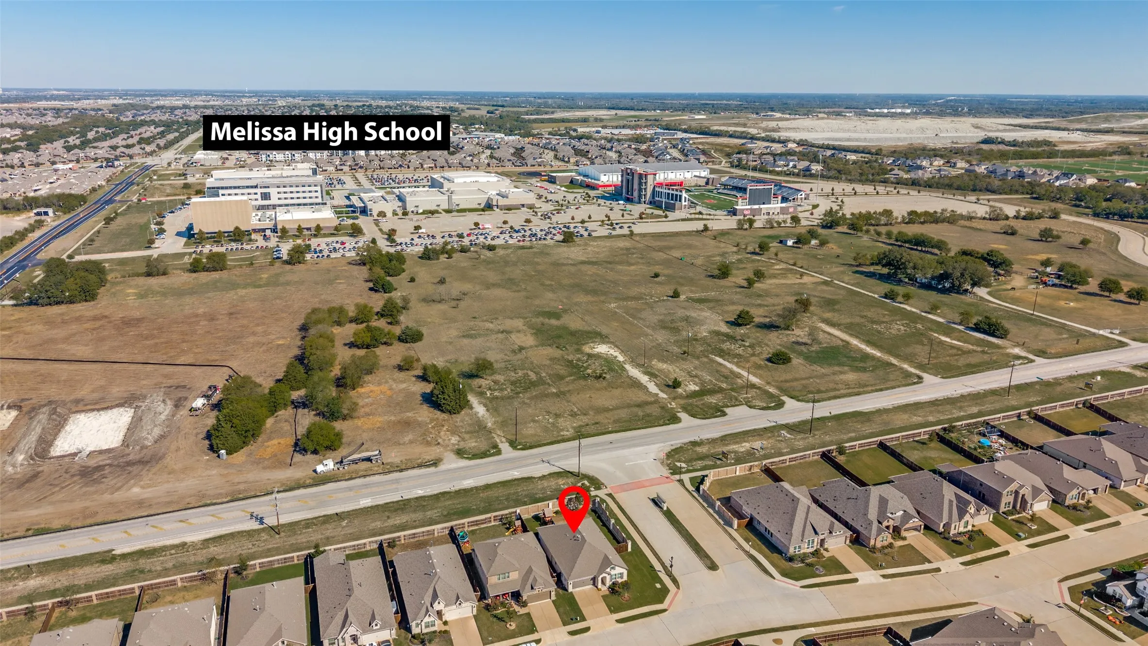 Aerial perspective of a residential property featuring proximity to Melissa High School and surrounding suburban development