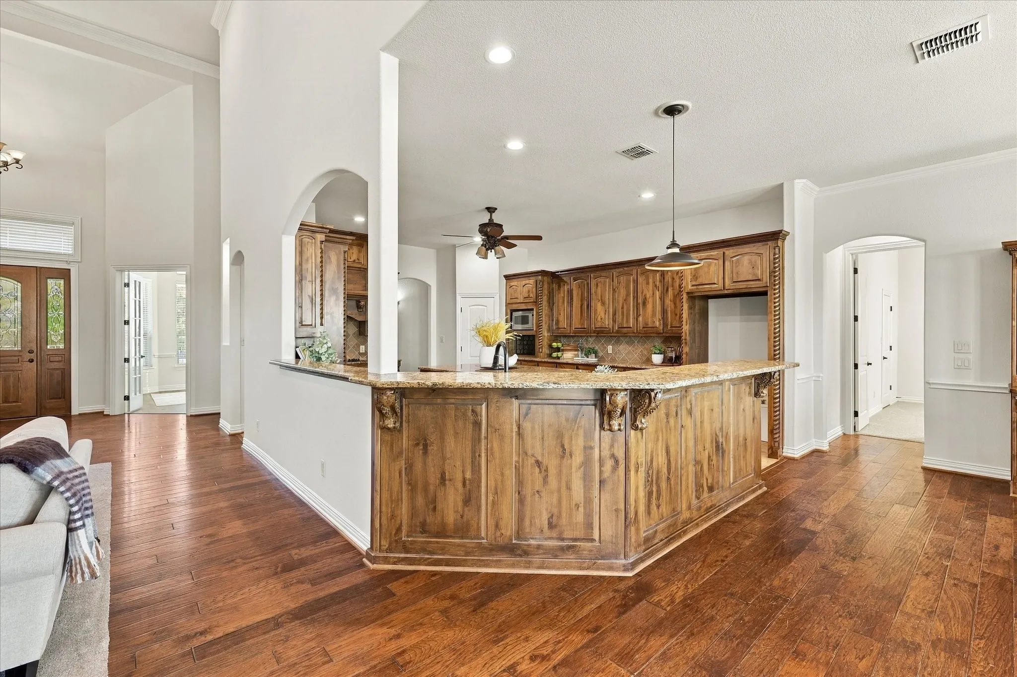 Impressive wrap-around, granite breakfast bar and custom woodwork details