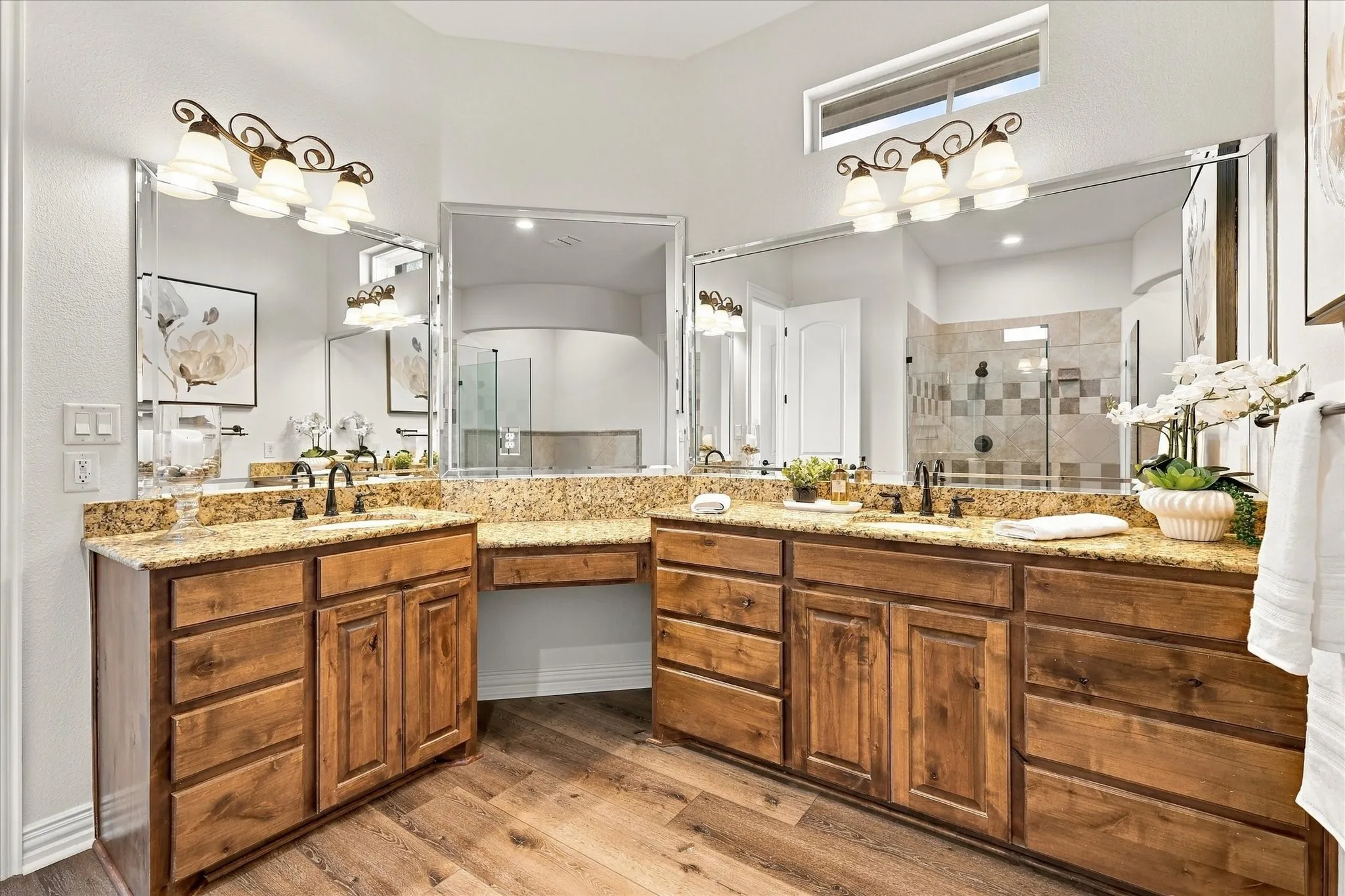 Beautiful dual-vanities and granite countertops.  Note small window for added natural light.