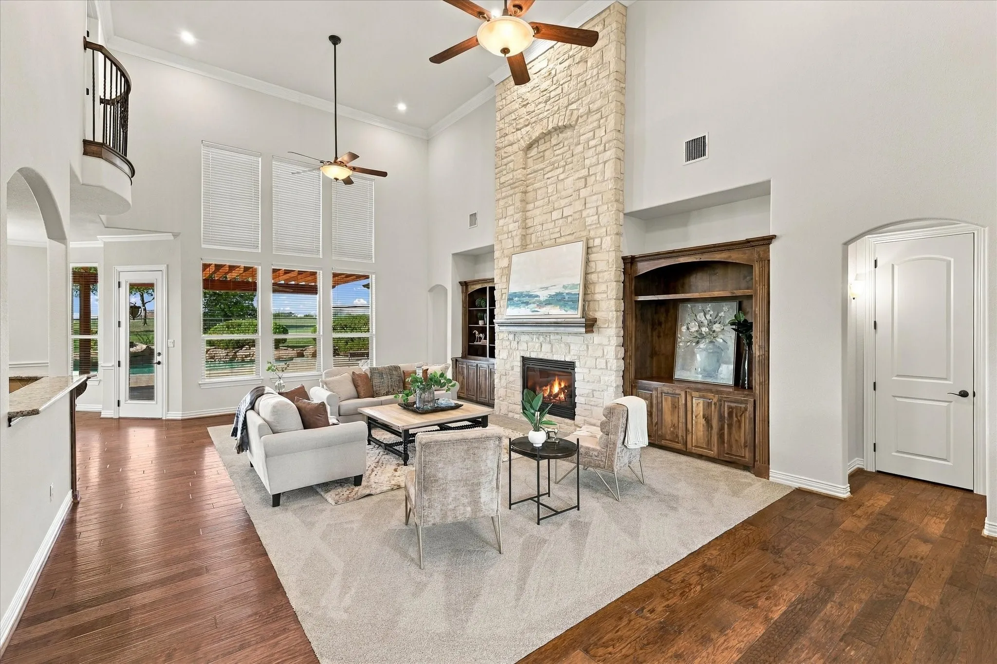 Two-story grand living space with floor-to-ceiling windows.