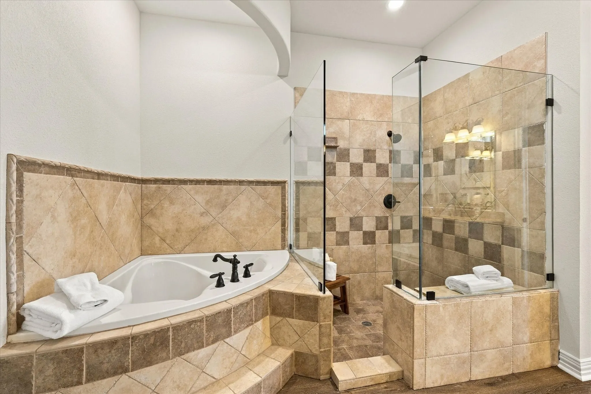 Garden tub and large frameless glass shower enclosure