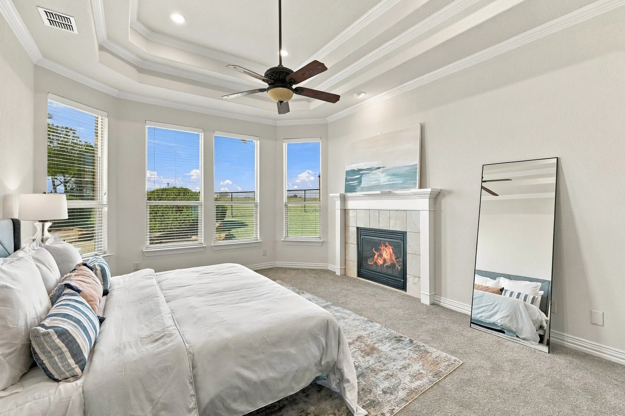 Glorious master suite overlooking back acreage with cozy fireplace