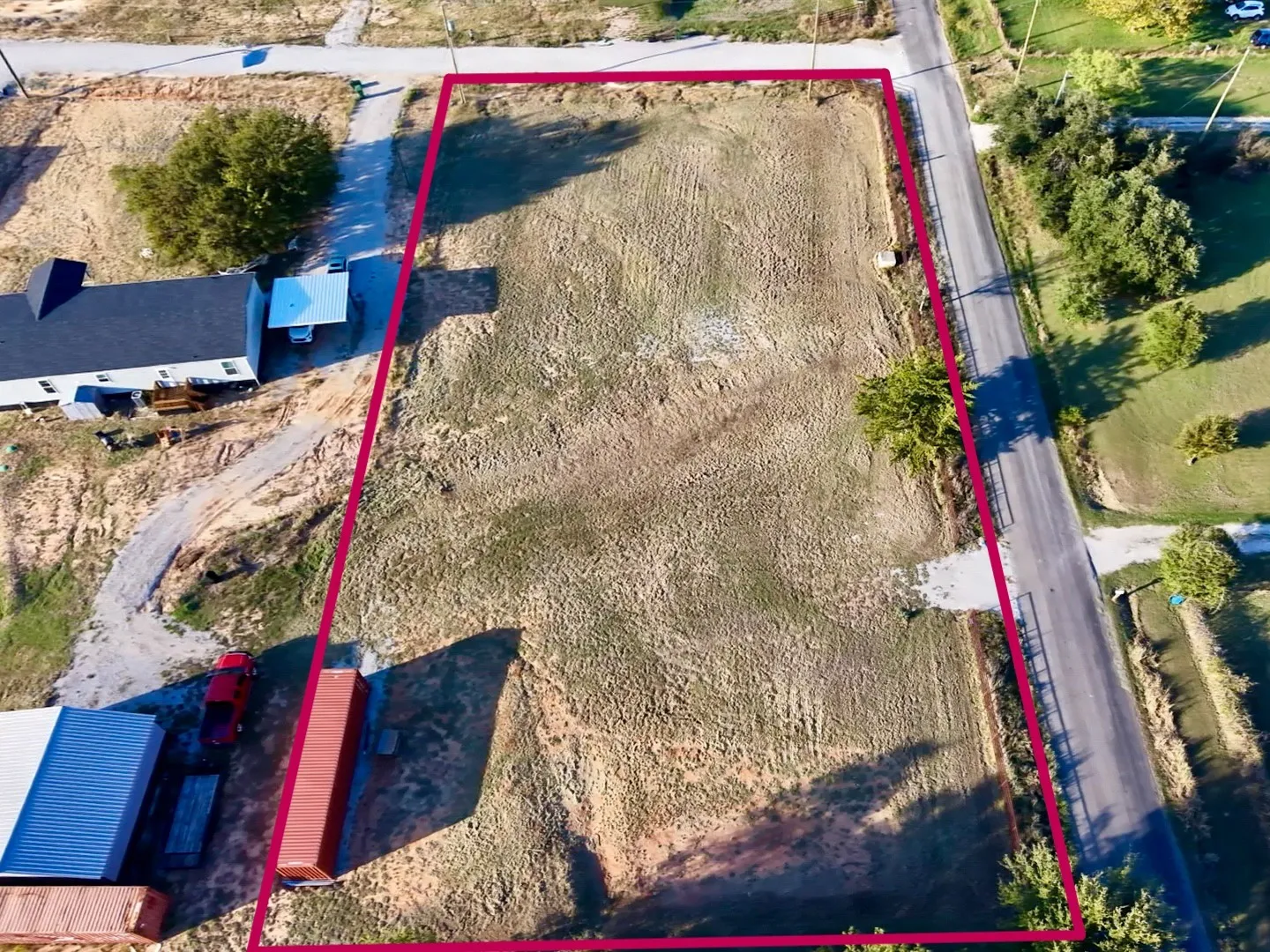 Rectangular parcel of cleared land with direct paved road frontage
