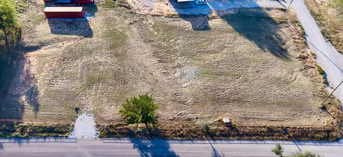 Cleared parcel featuring level topography, corner lot positioning, and paved road access
