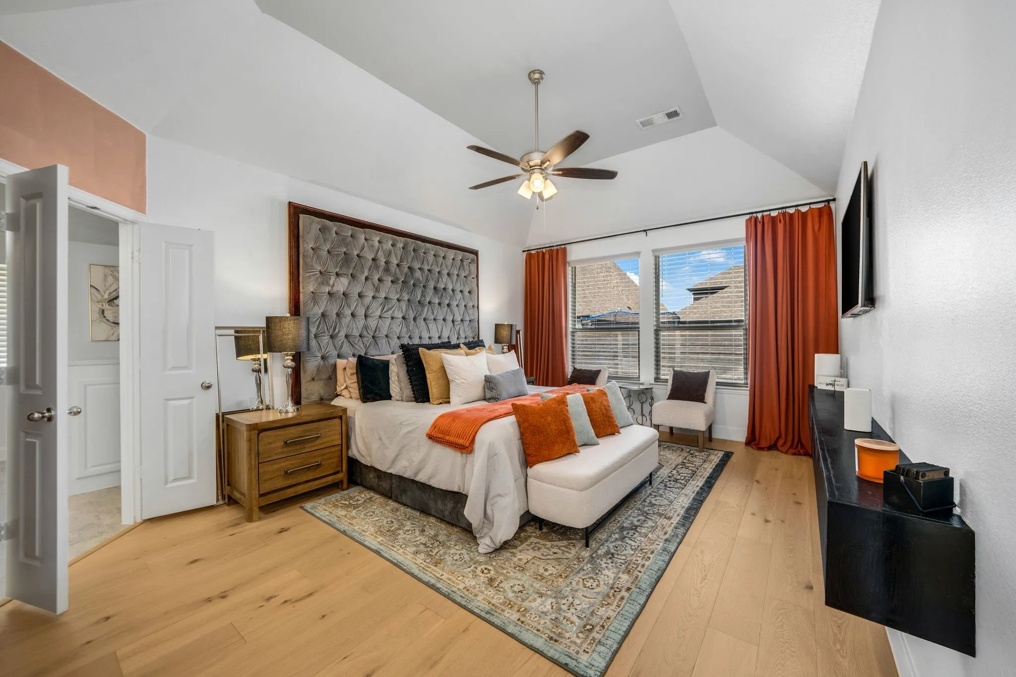 Vaulted ceilings, wood-finish flooring, and a wall-mounted floating console