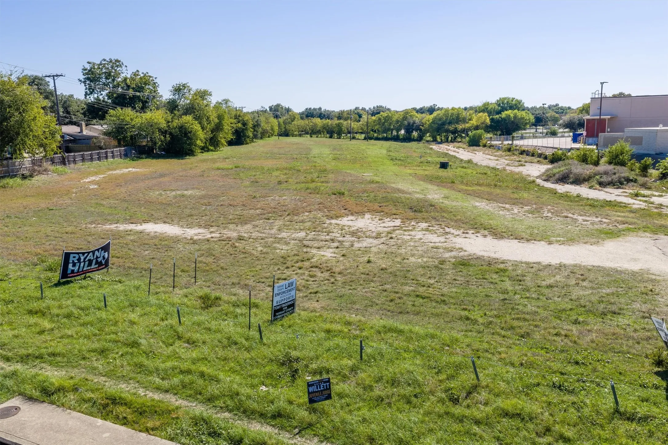 Expansive parcel of land featuring open terrain, mature perimeter trees, and a clear expanse