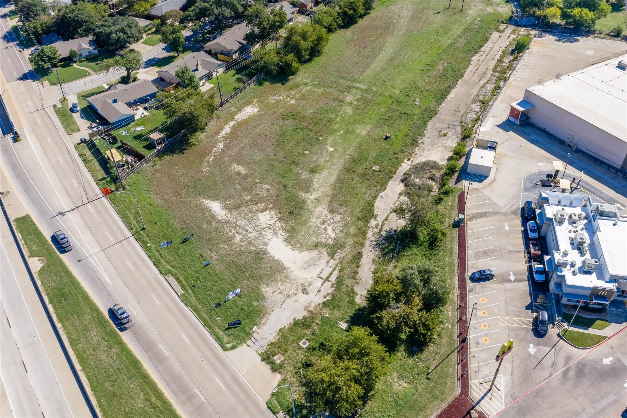 Expansive parcel of land featuring direct road frontage and prominent visibility