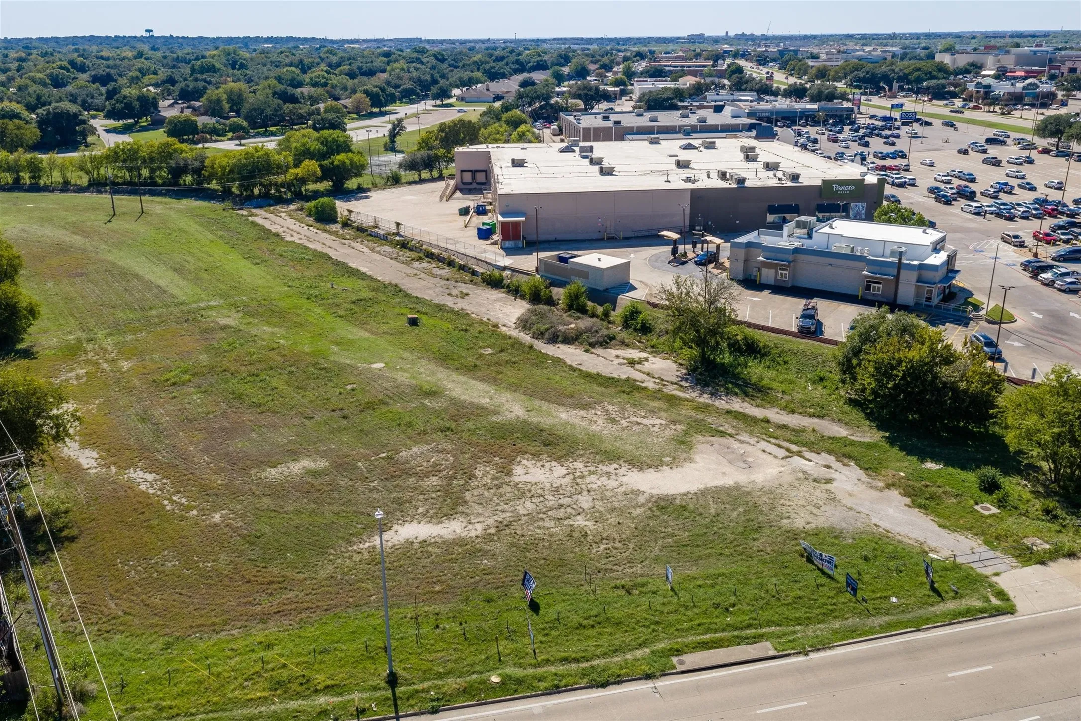 Expansive cleared lot featuring street frontage, utility access, and proximity to commercial infrastructure