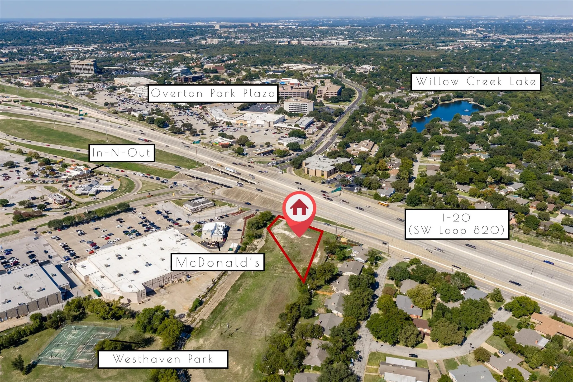 Aerial perspective of a cleared parcel featuring direct proximity to I-20 and SW Loop 820, with local commercial centers and green space within the surrounding area