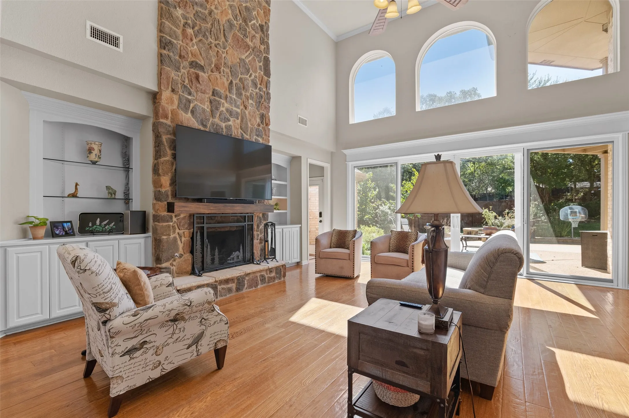 Familyroom with decorative stone fireplace and lots of natural light!